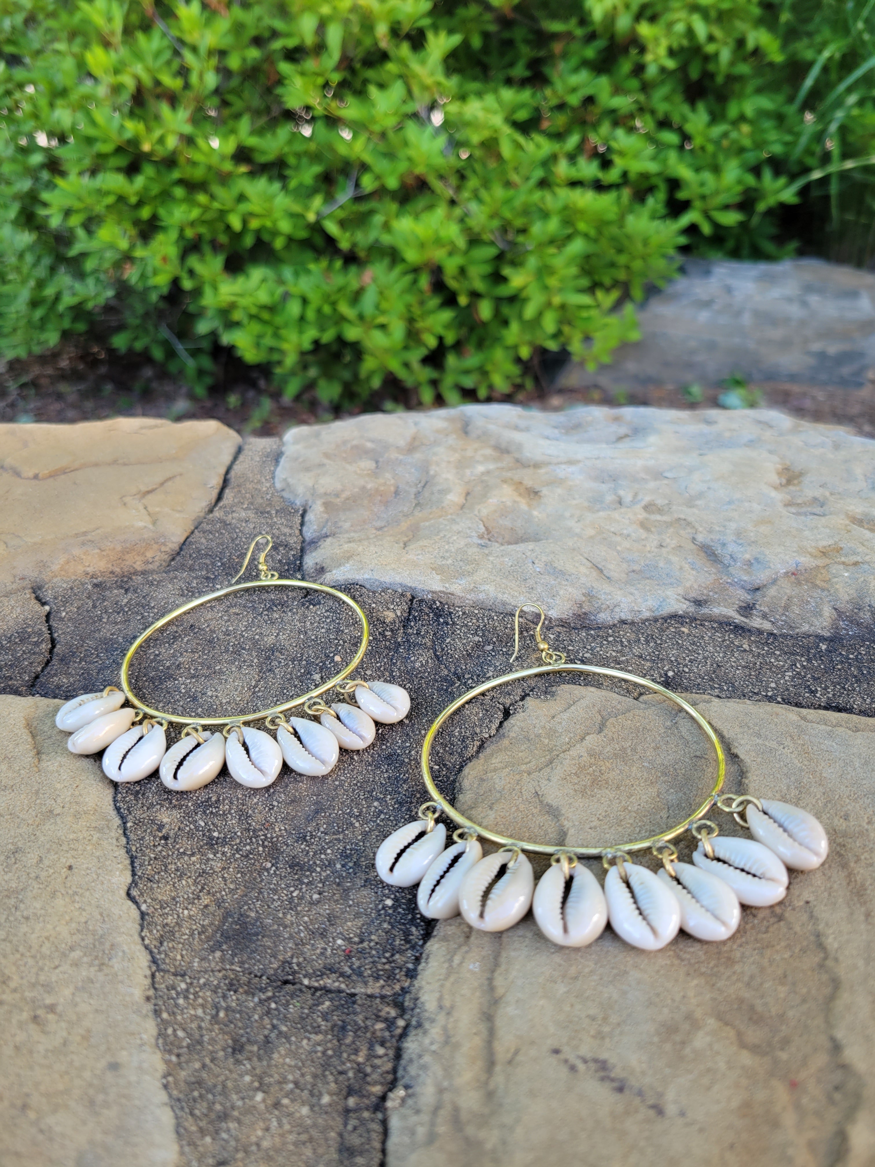 Cowrie Shell Hoop Earrings with 8 cowrie shells cascading from a large brass hoop.