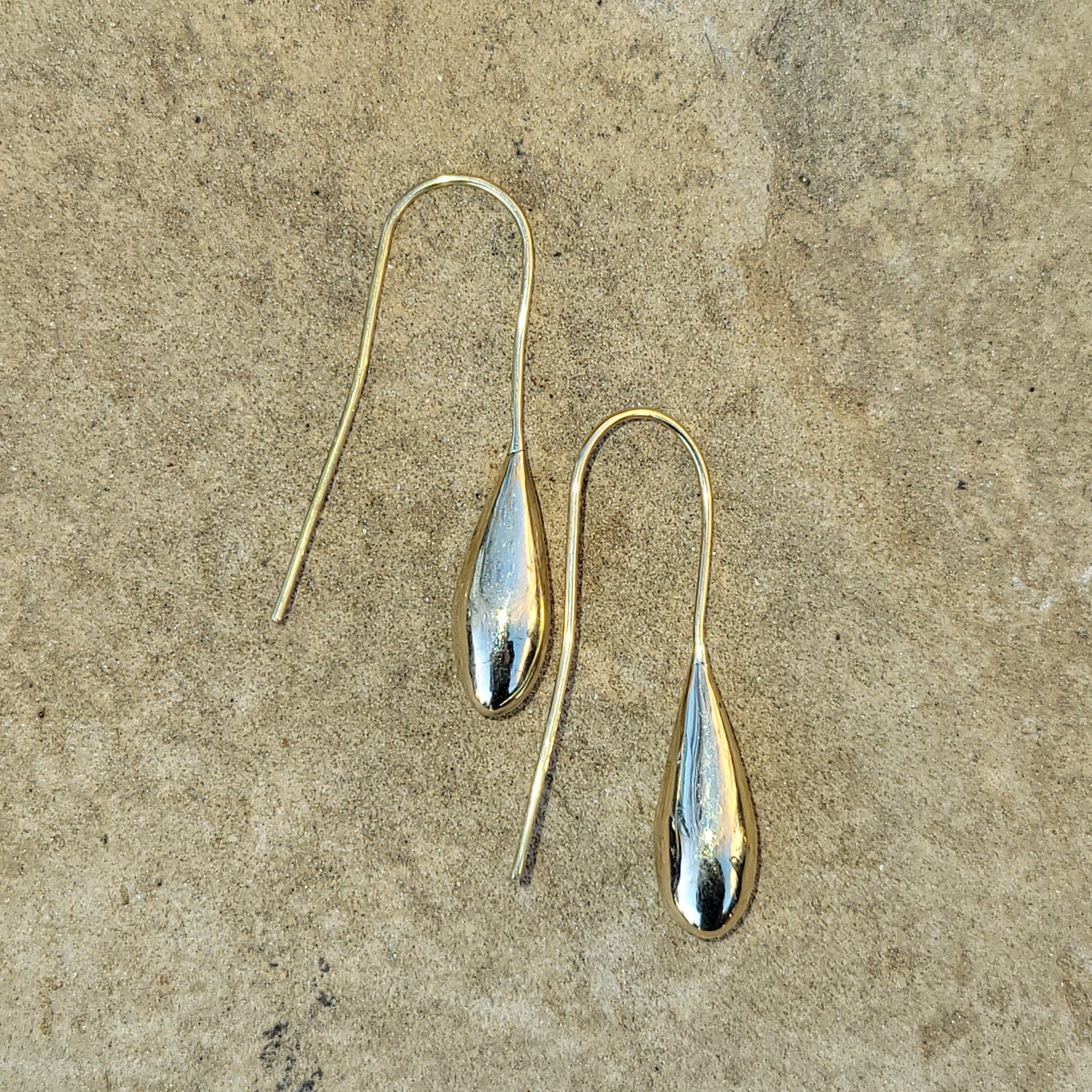 An image of gold-color Simple teardrop brass forms on sleek threaders. Shop Kamawe
