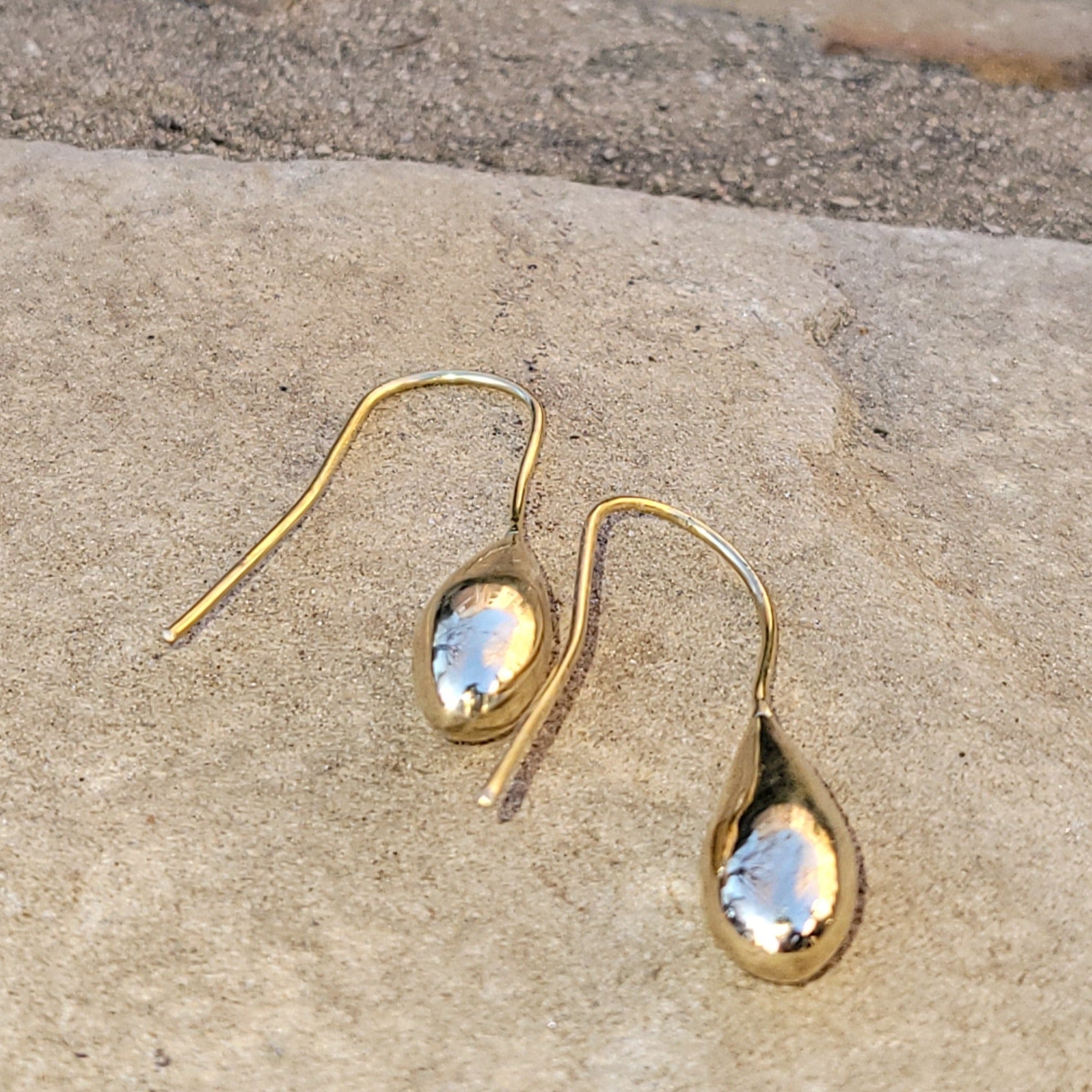 An image of gold-color Simple teardrop brass forms on sleek threaders. Shop Kamawe