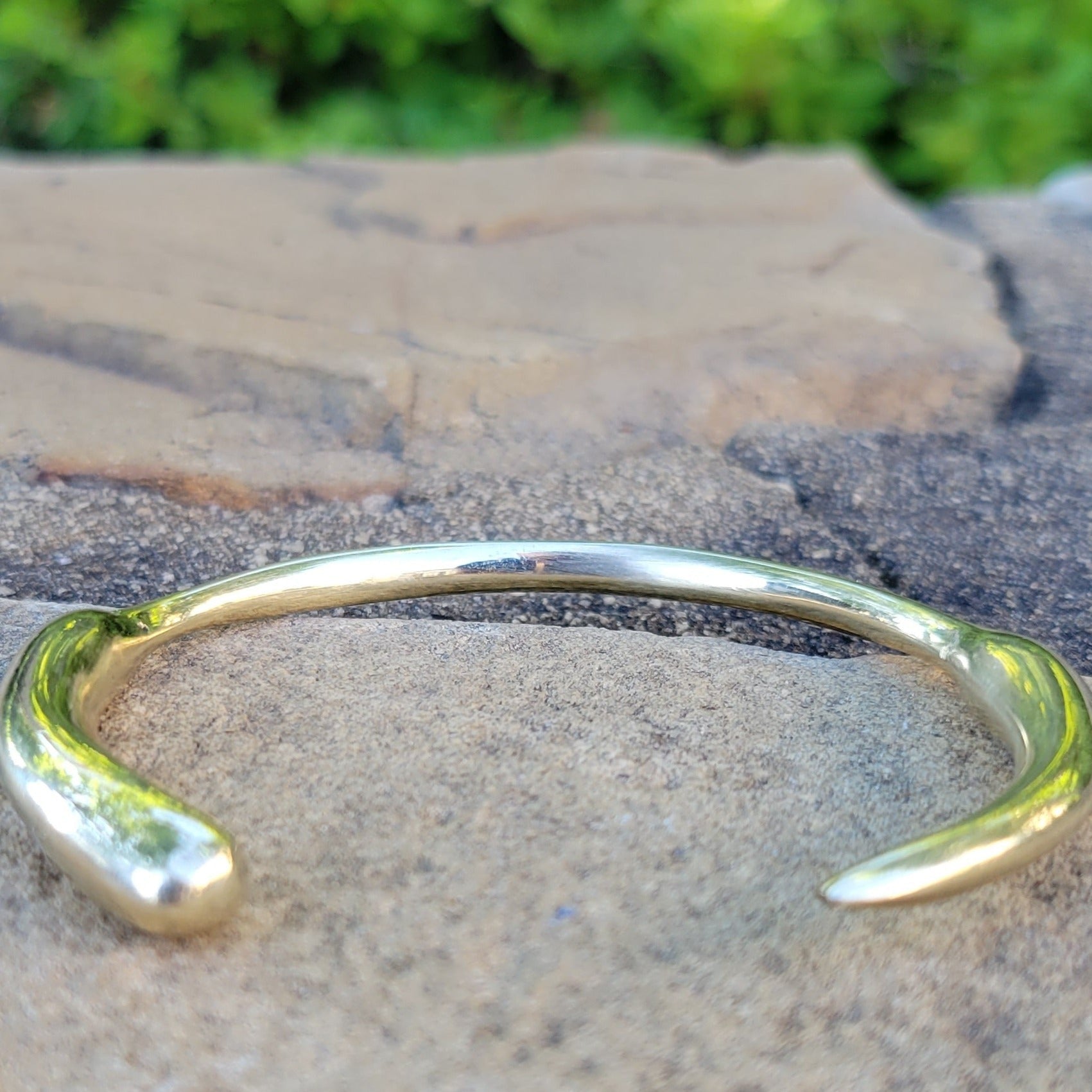 An image of Polished jagged-edge cuff inspired by a lion’s tooth. Shop Kamawe
