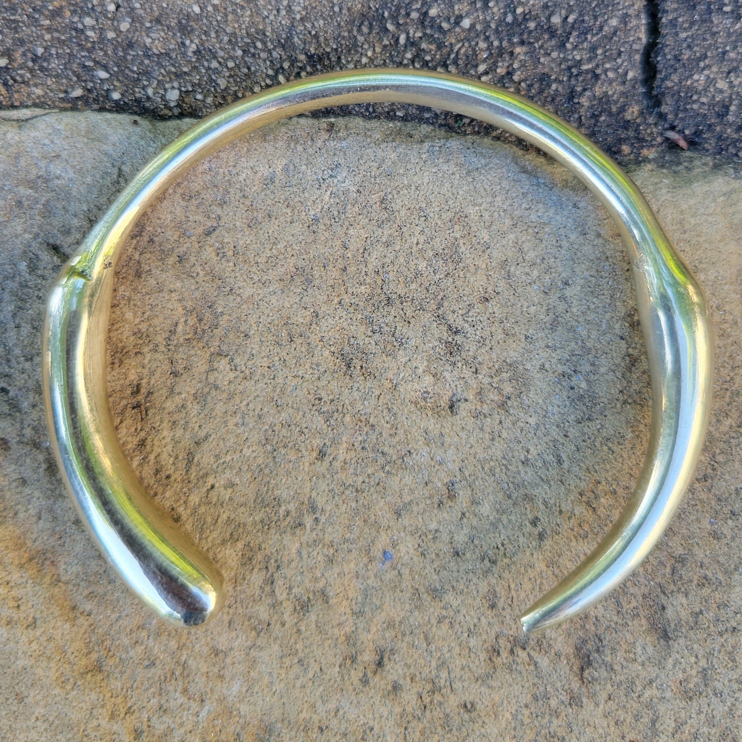An image of Polished jagged-edge cuff inspired by a lion’s tooth. Shop Kamawe
