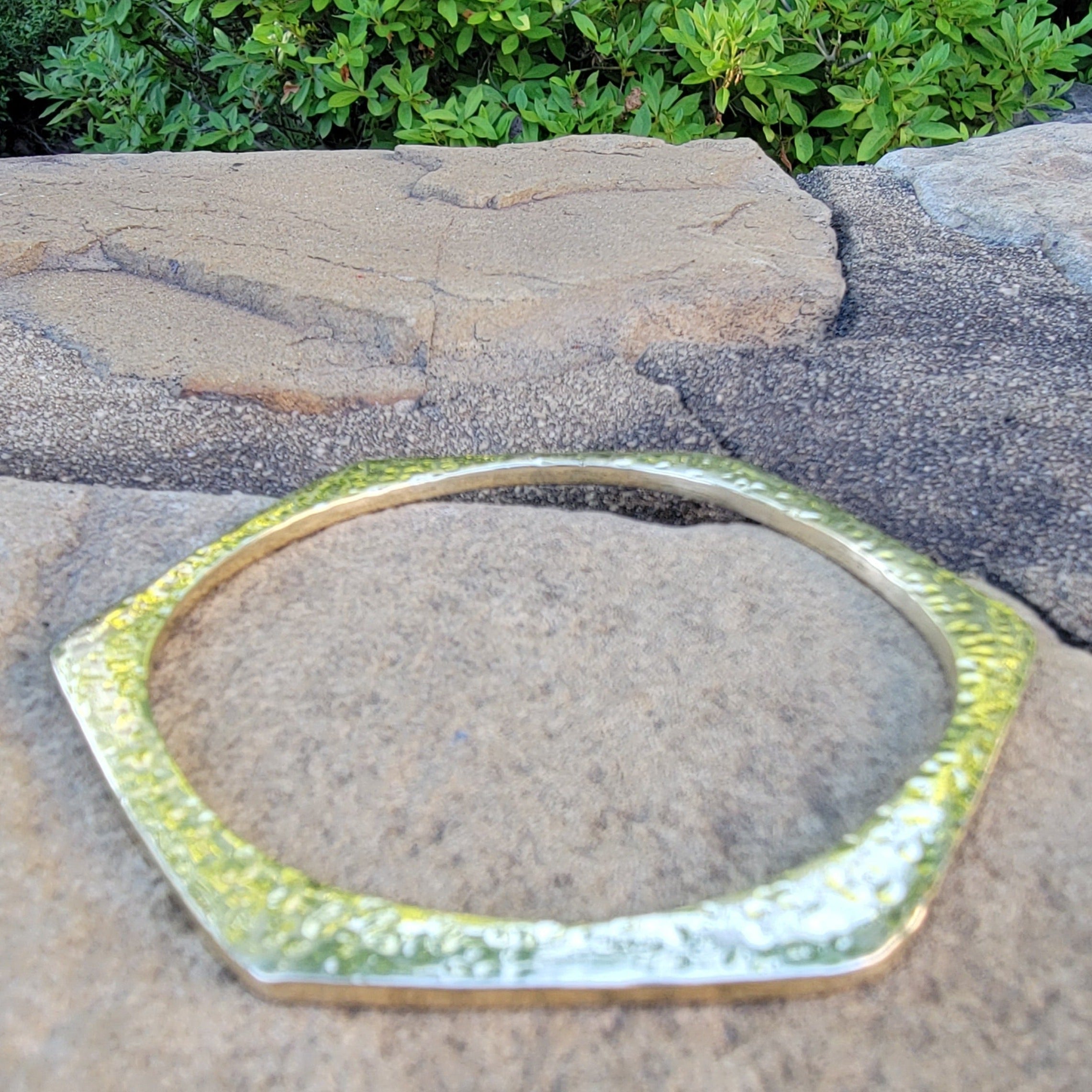 An image of gold-color Six-sided hammered brass cuff with sharp geometry. Shop Kamawe
