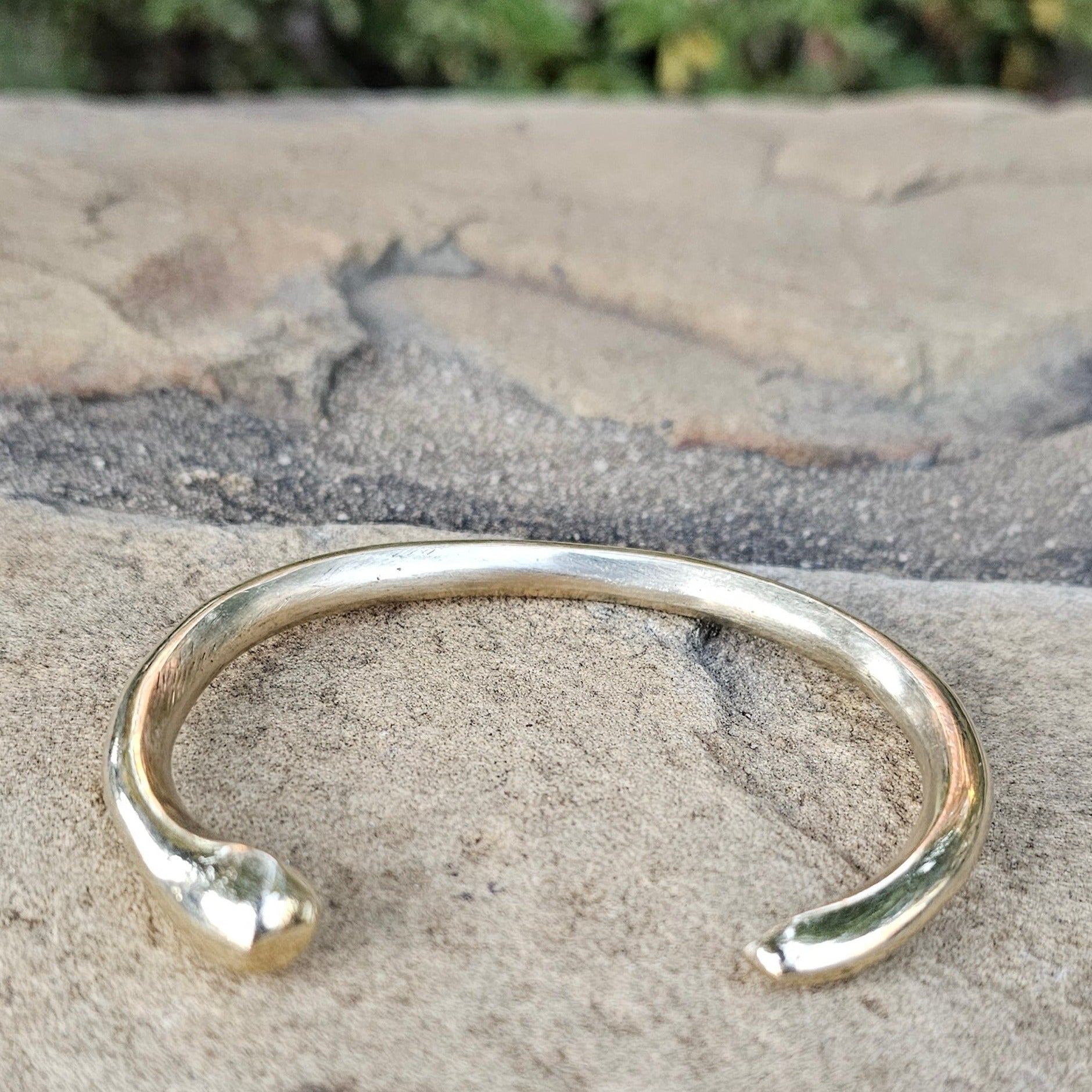 An image of Bold open-tusk cuff with dramatic curve. Shop Kamawe
