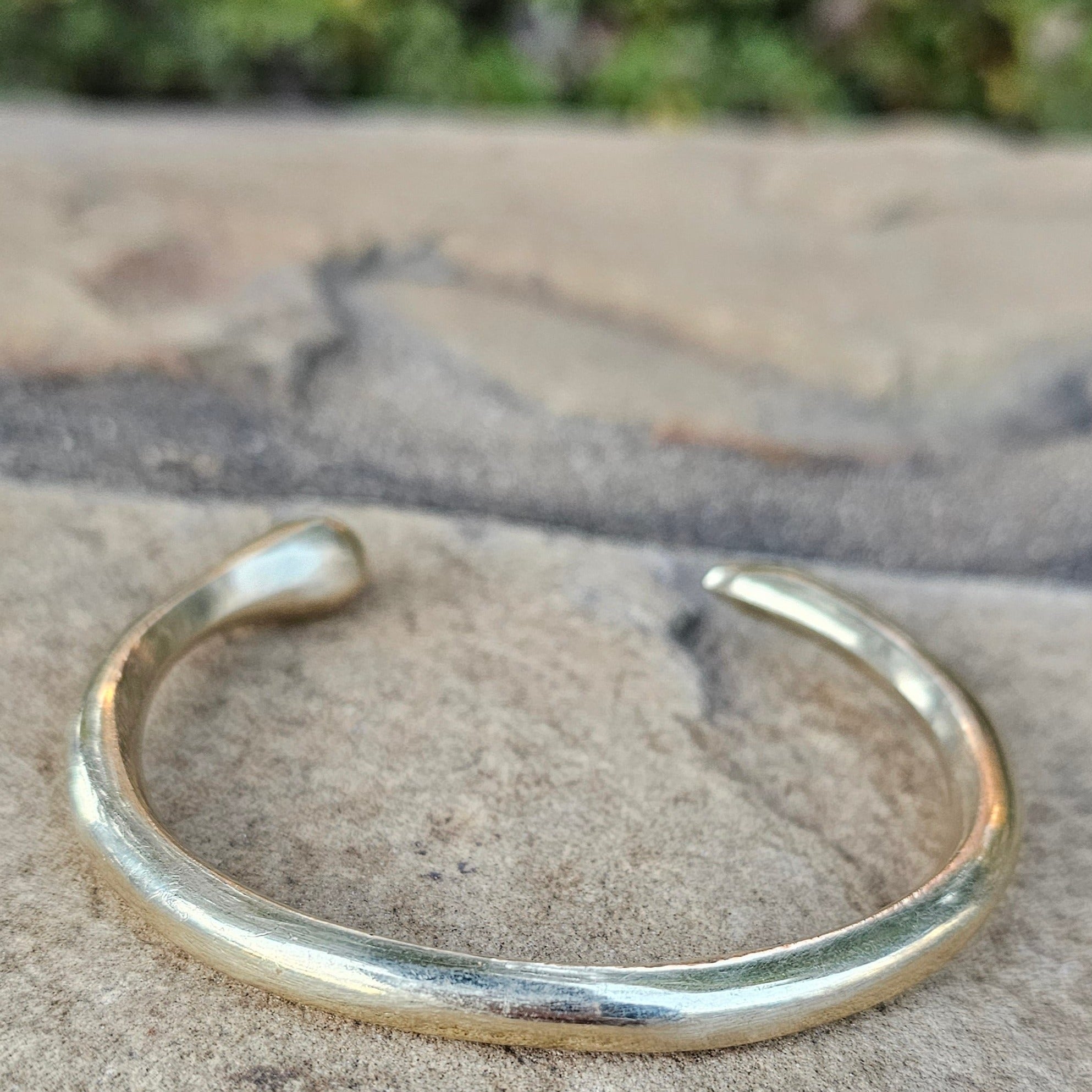 An image of Bold open-tusk cuff with dramatic curve. Shop Kamawe