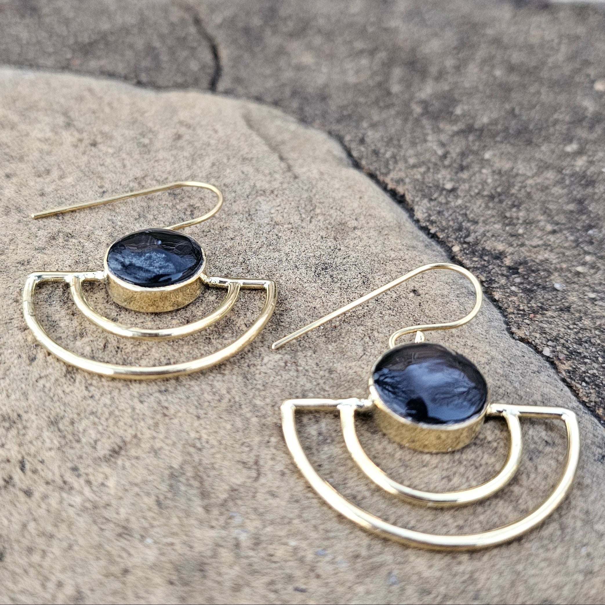 An image of gold & black-color Sleek crescent brass earrings with shadowed finish. Shop Kamawe