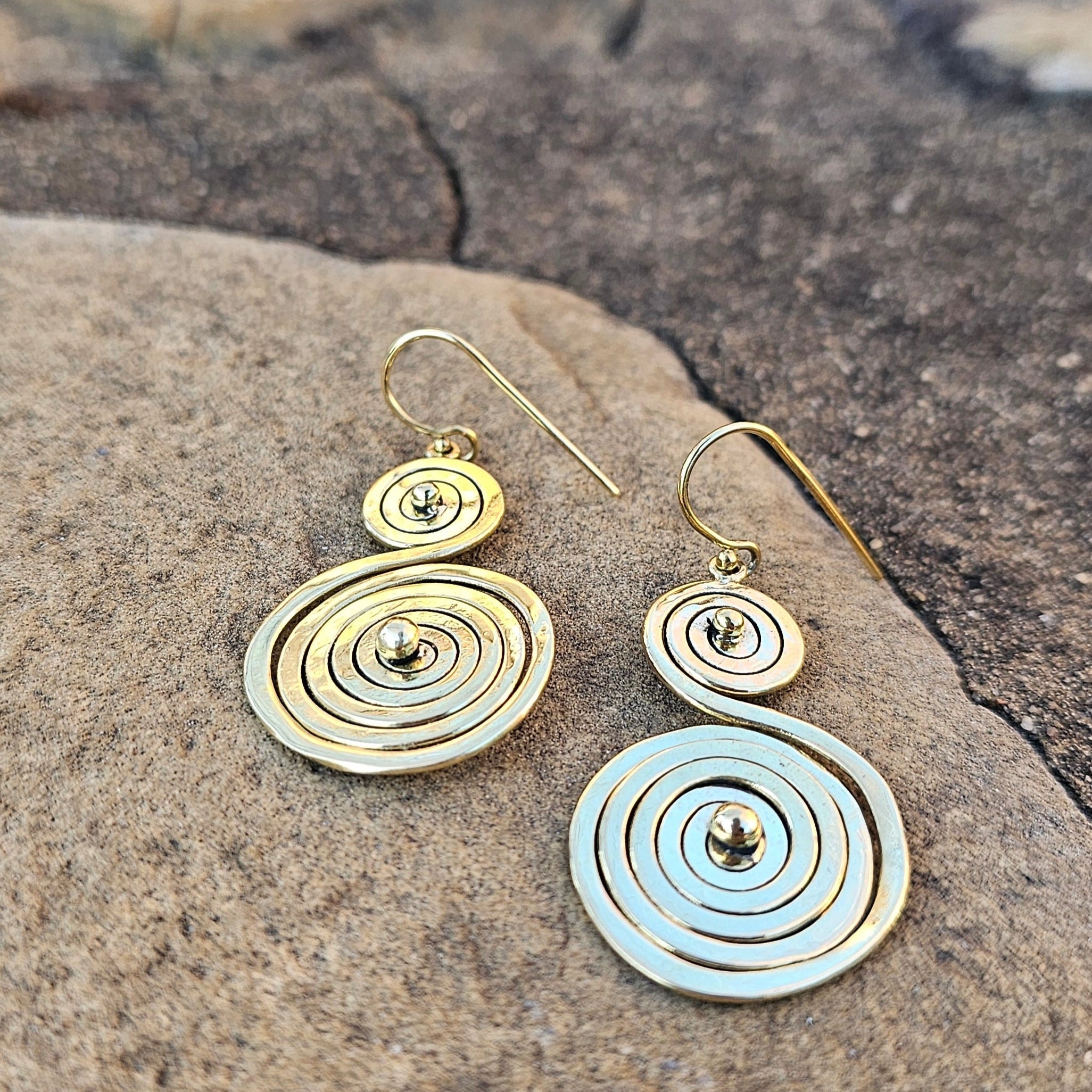 An image of gold-color Twisting double-spiral brass drop earrings. Shop Kamawe