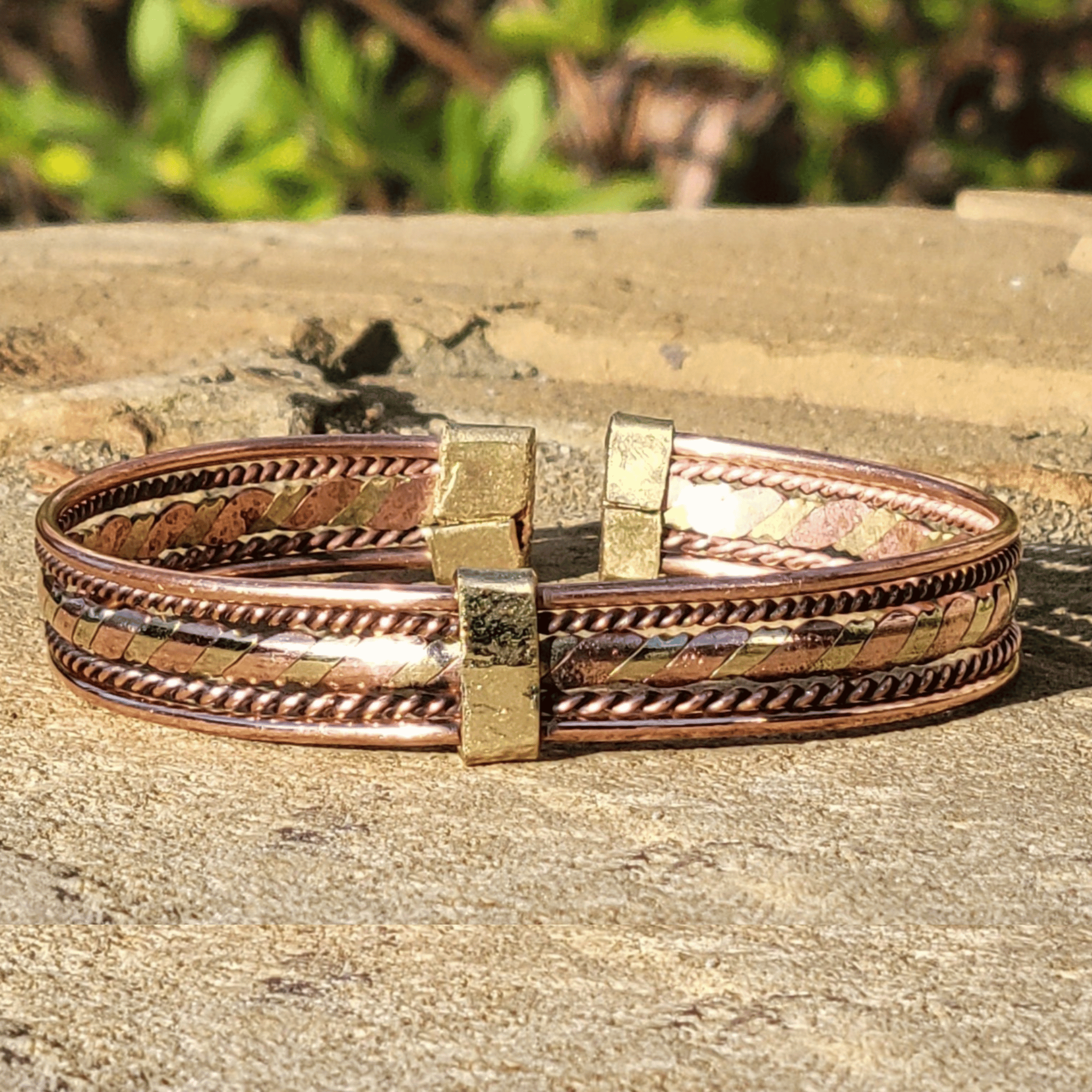 An image of Interwoven flat twist of brass and copper. Shop Kamawe