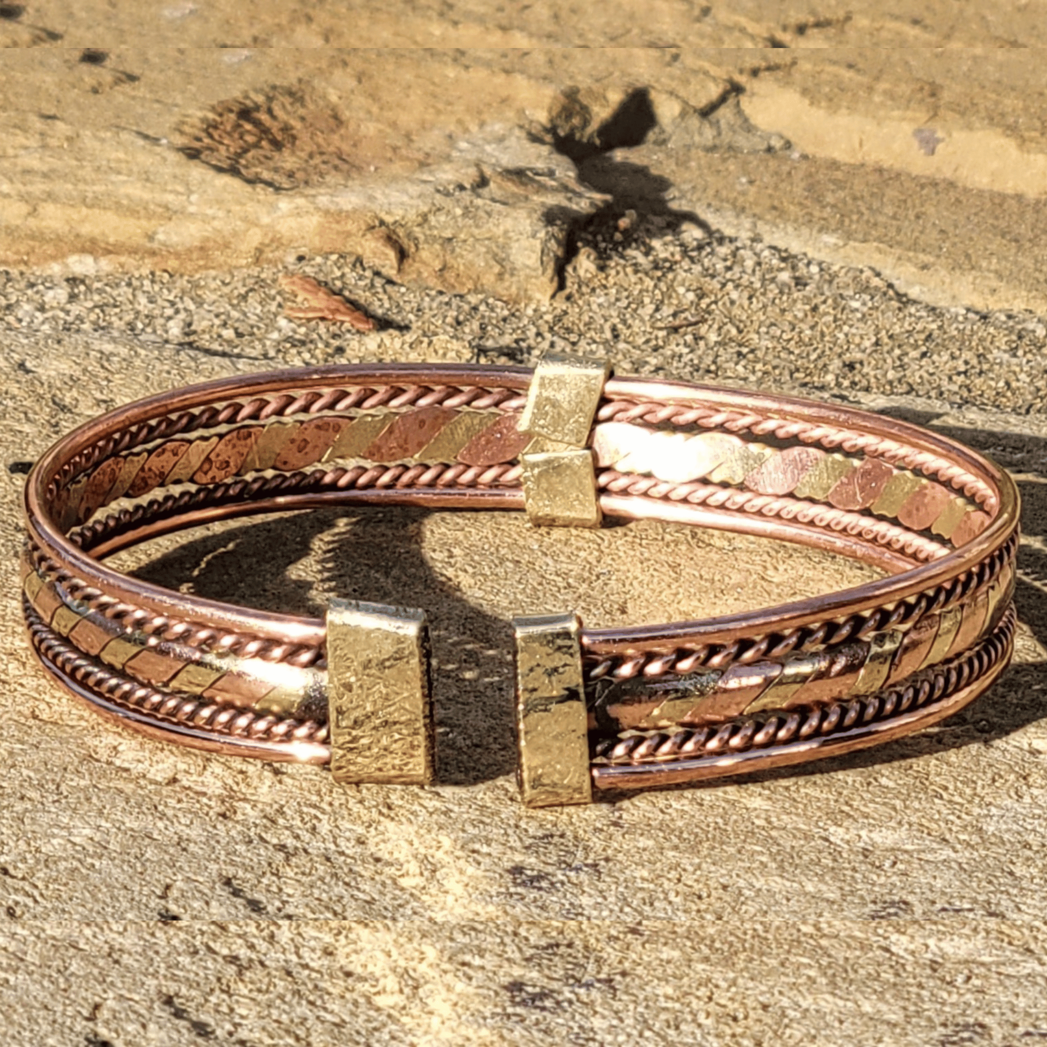 An image of Interwoven flat twist of brass and copper. Shop Kamawe