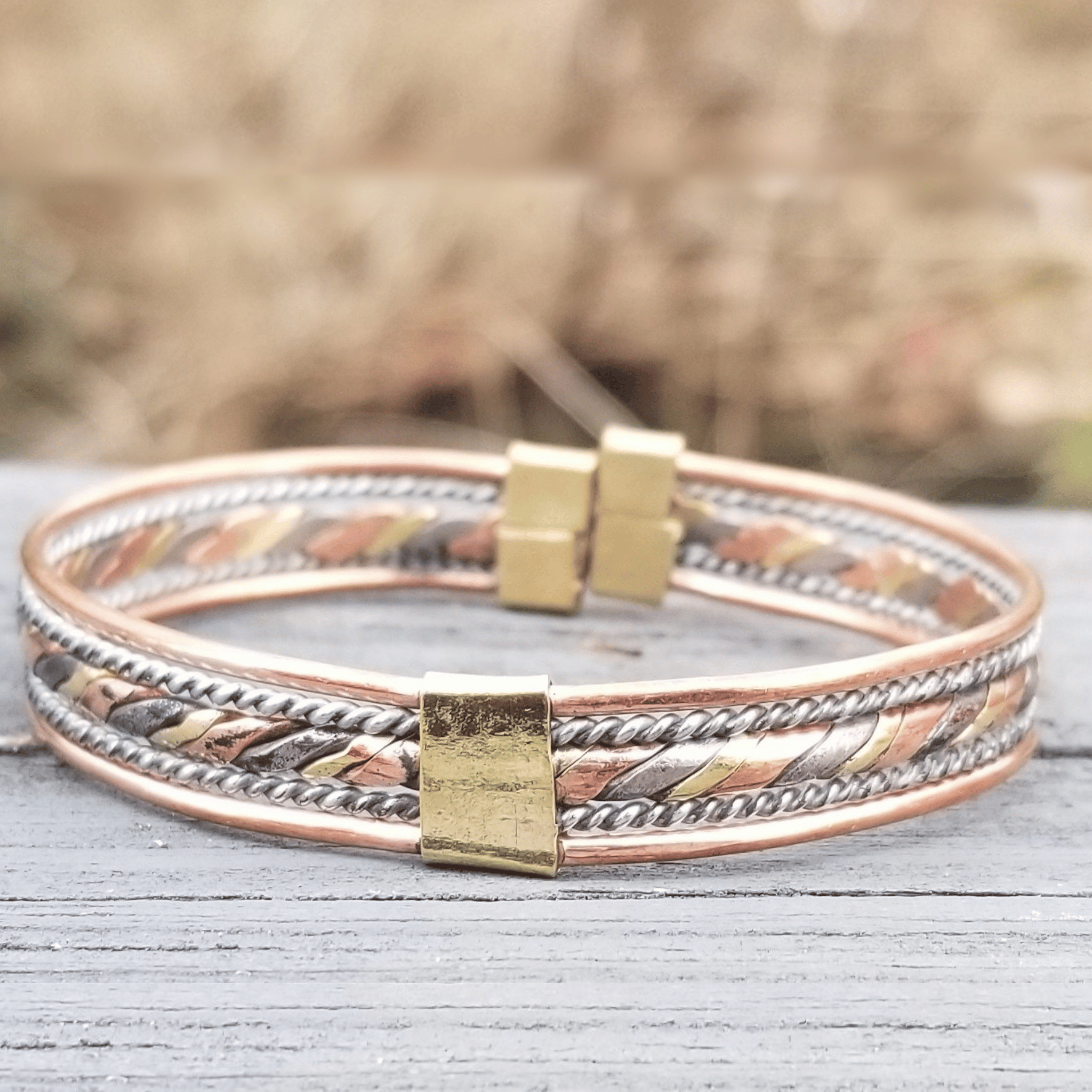 An image of Flattened twist combining different metallic tones. Shop Kamawe