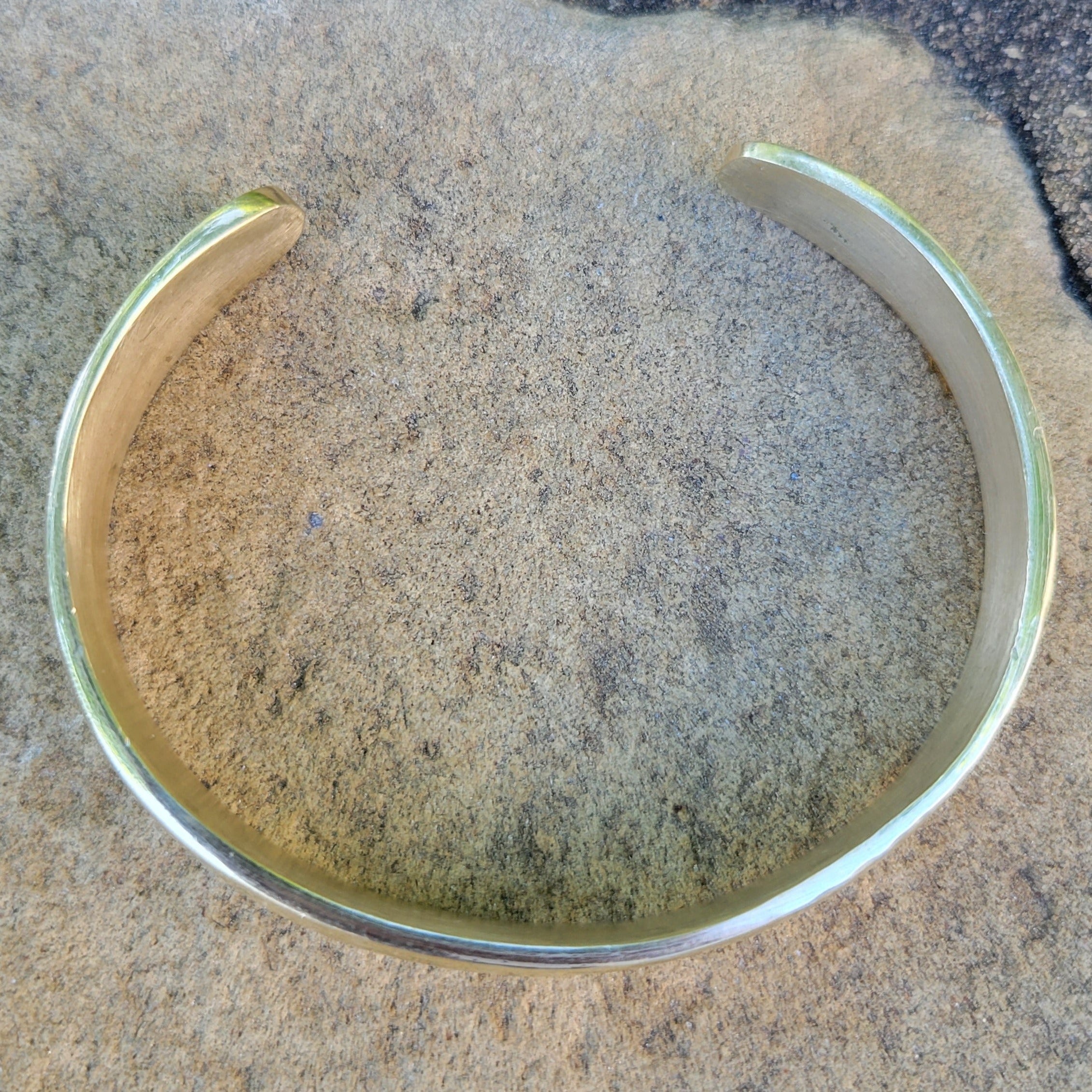 An image of Simple open cuff finished with organic hammer marks. Shop Kamawe