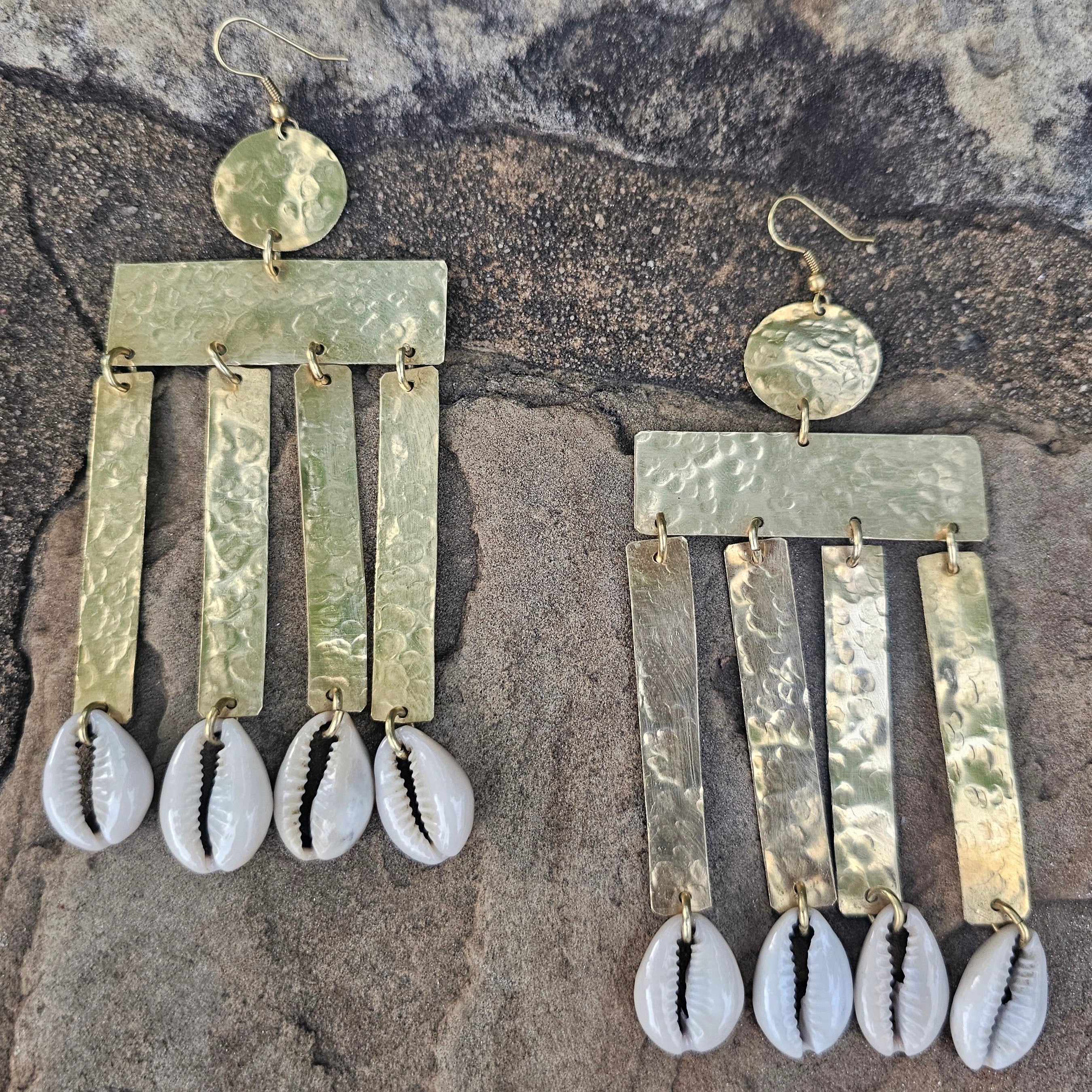 An image of gold & beige-color Ribbed brass column earrings finished with cowrie. Shop Kamawe