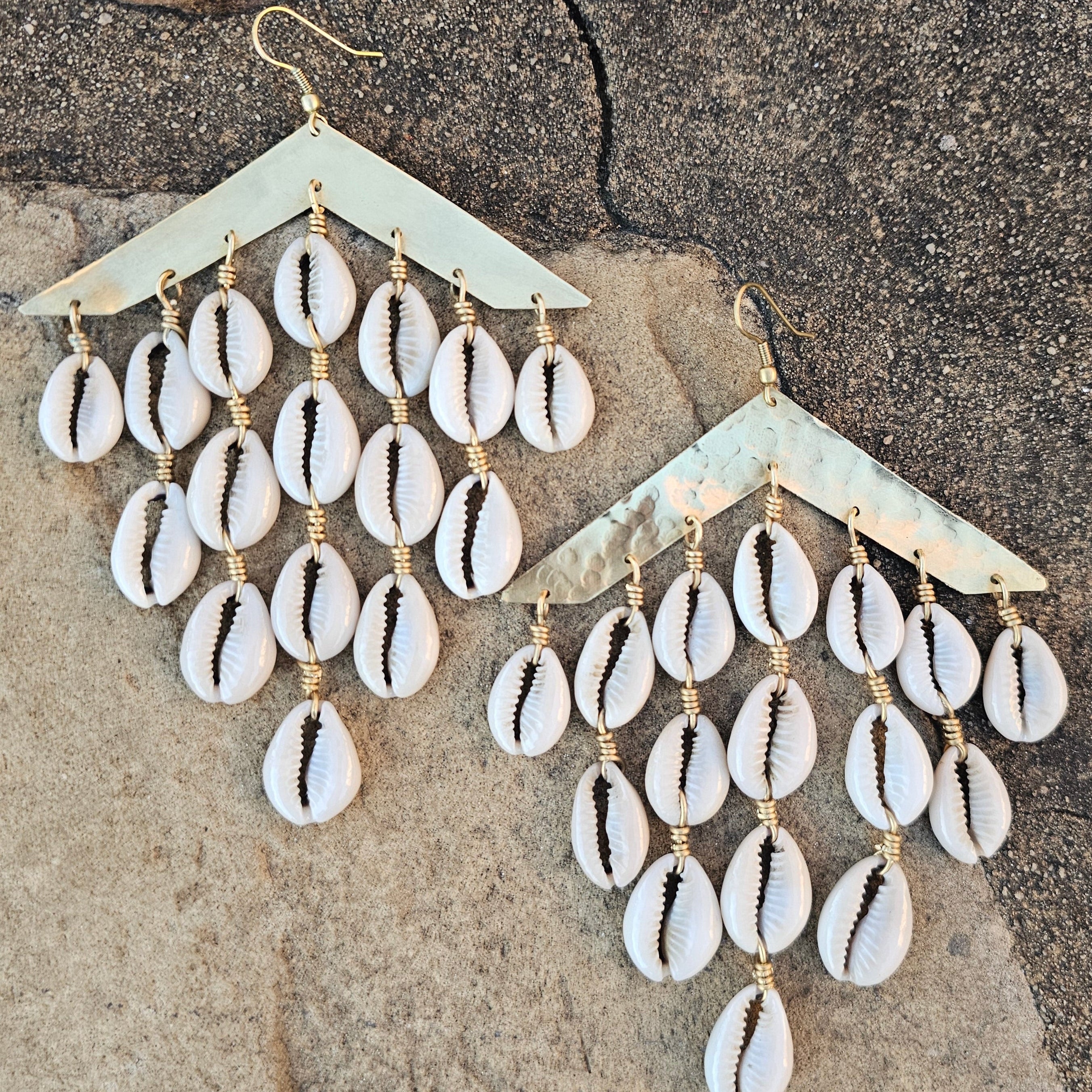 An image of gold & beige-color Layered hammered brass bars with cascading cowrie. Shop Kamawe