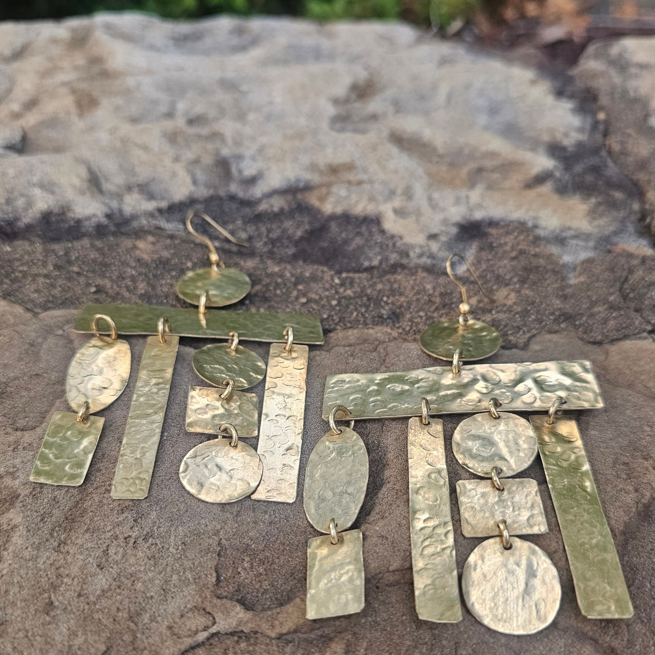 An image of gold-color Rough-finished interlocking brass puzzle drops. Shop Kamawe