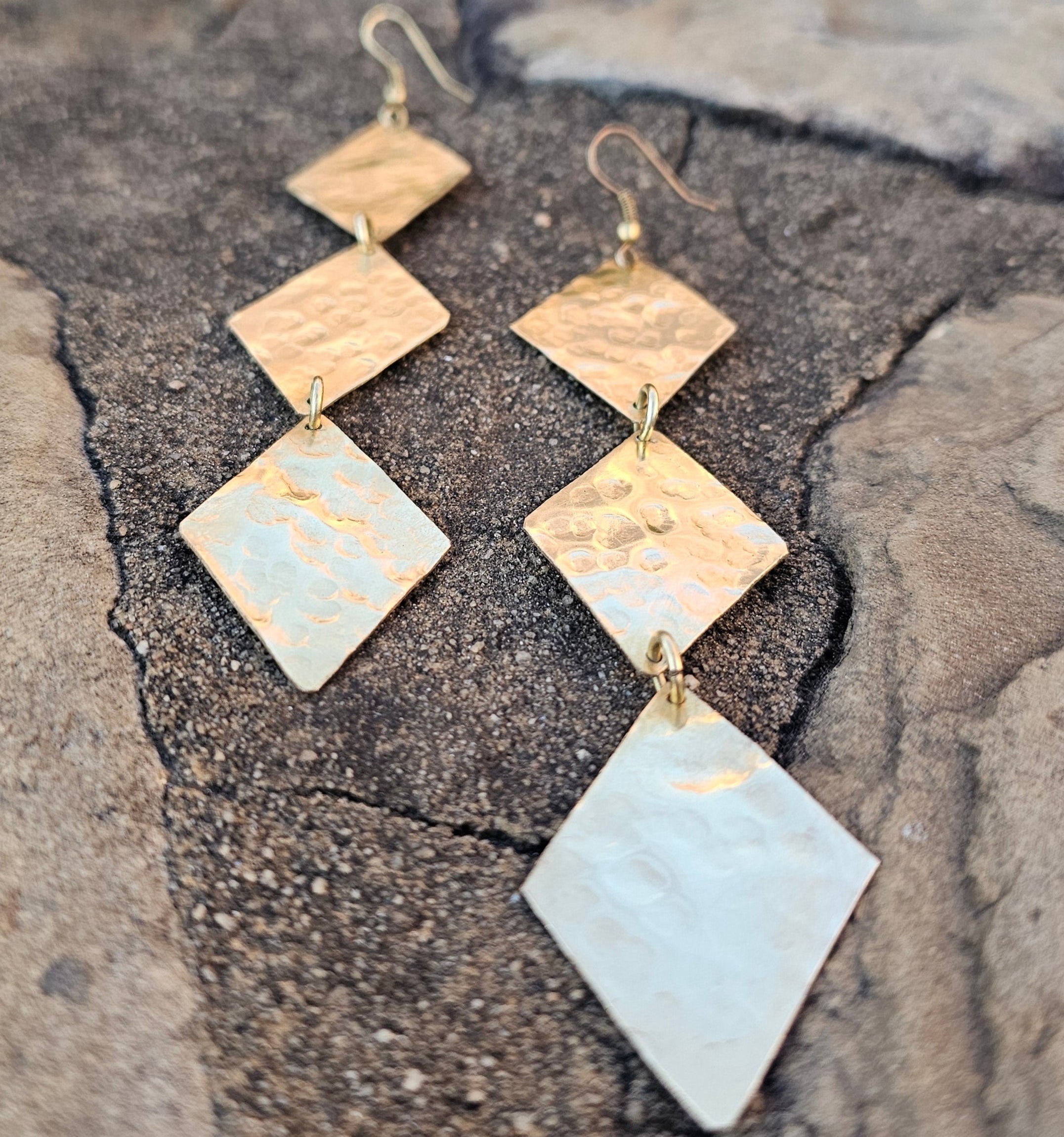 An image of gold-color Textured trio of diamond brass drops. Shop Kamawe