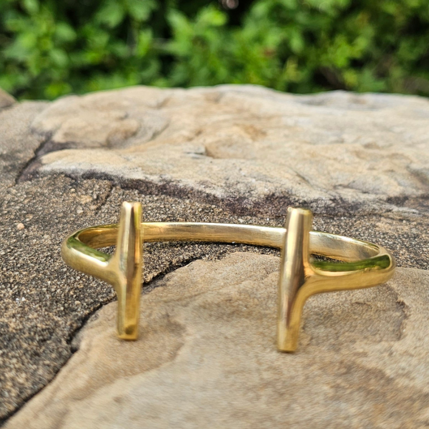 An image of gold-color Parallel-line brass bracelet with architectural simplicity. Shop Kamawe