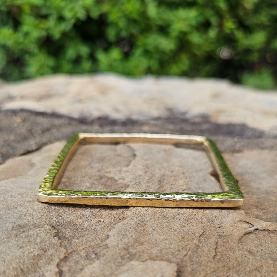 An image of gold-color Three-dimensional hammered cube brass bangle. Shop Kamawe