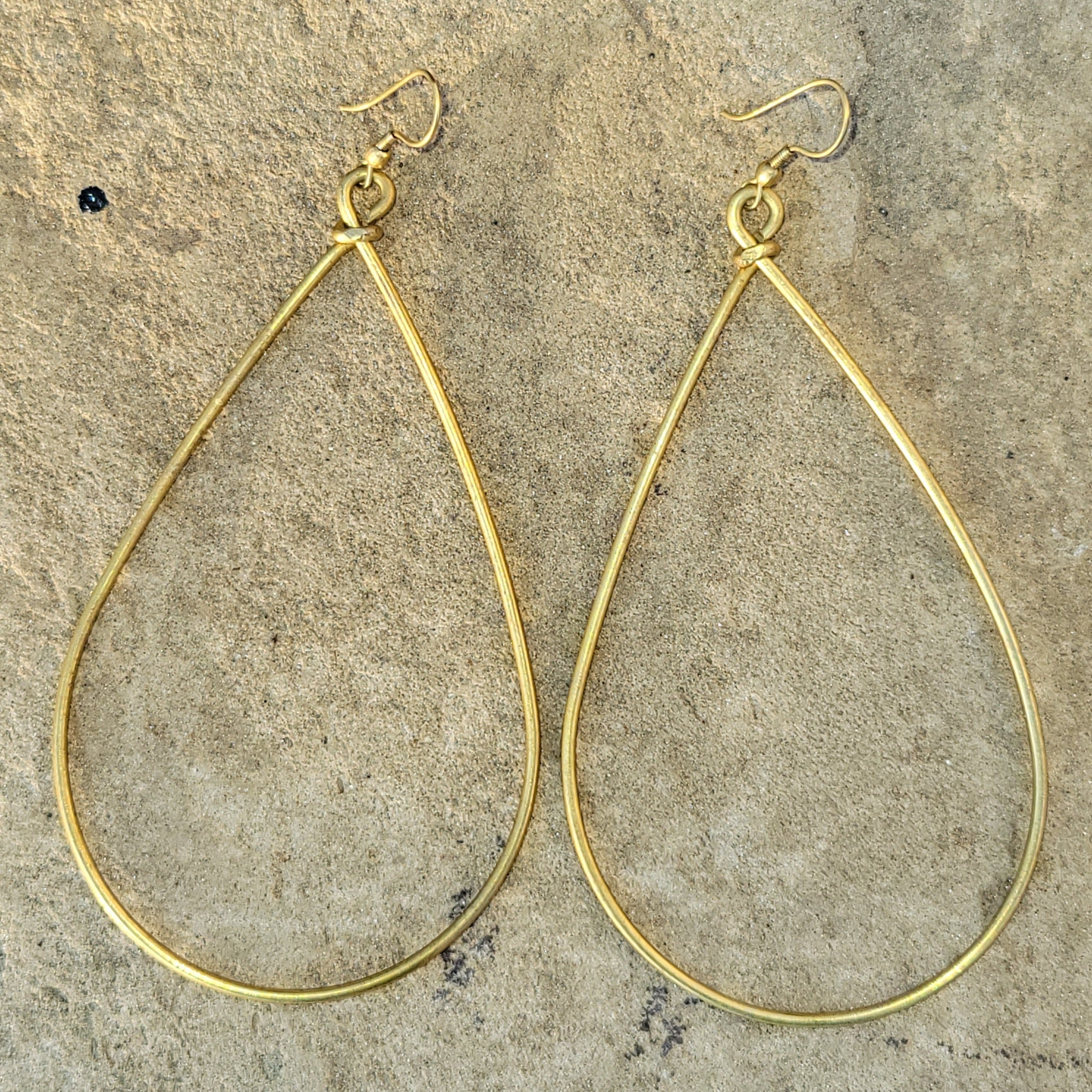 An image of gold-color Bold oversized teardrop drops in smooth brass. Shop Kamawe