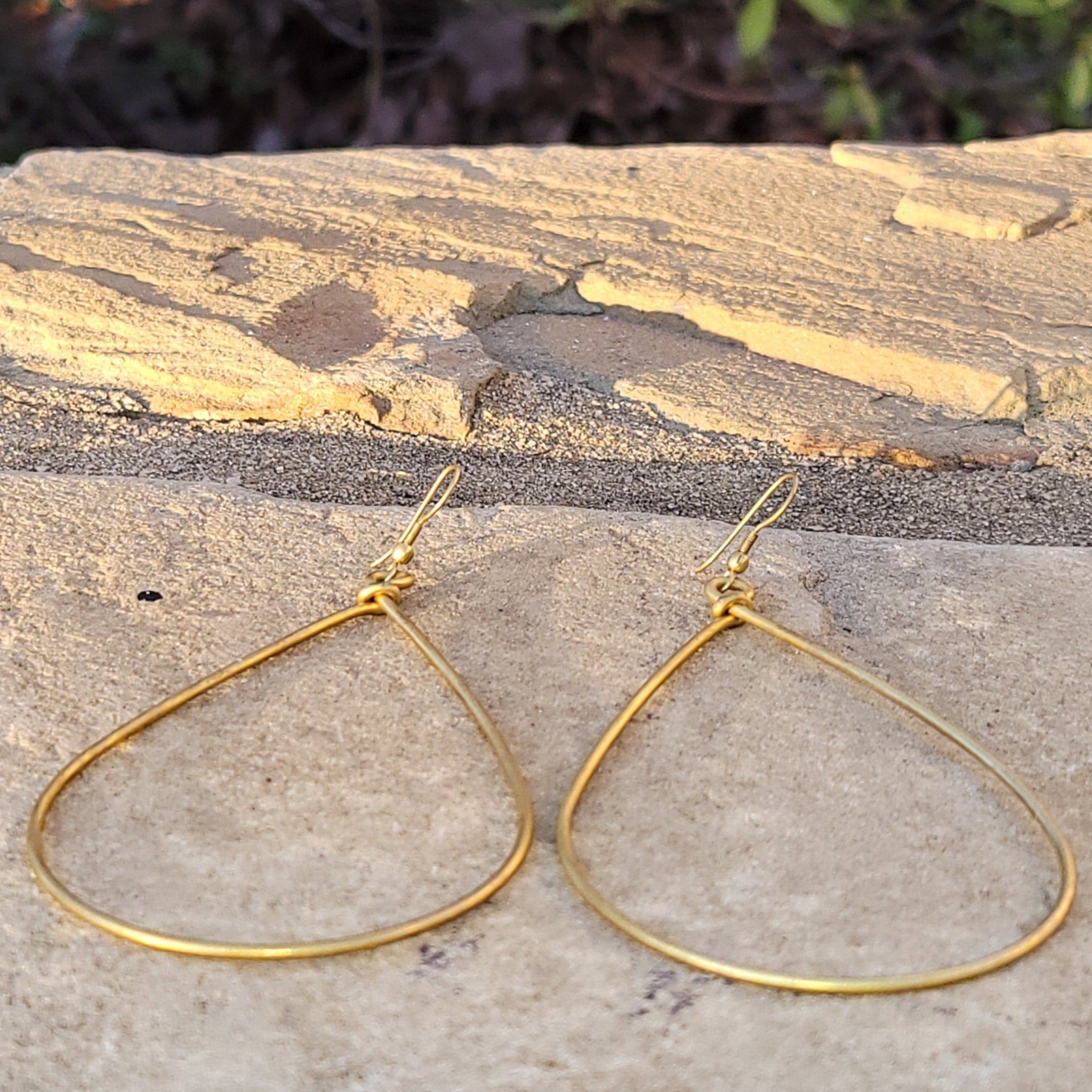 An image of gold-color Bold oversized teardrop drops in smooth brass. Shop Kamawe