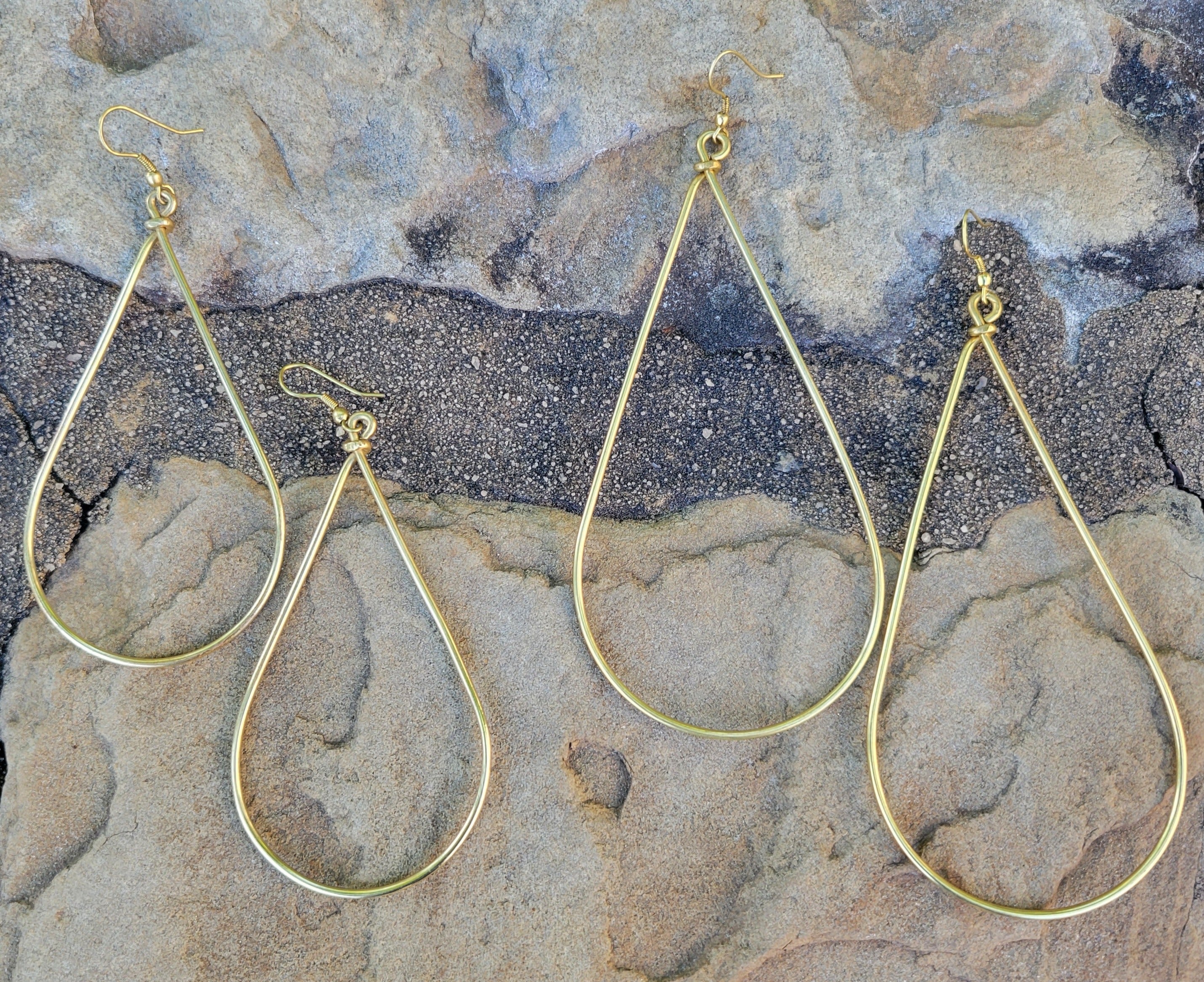 An image of gold-color Bold oversized teardrop drops in smooth brass. Shop Kamawe