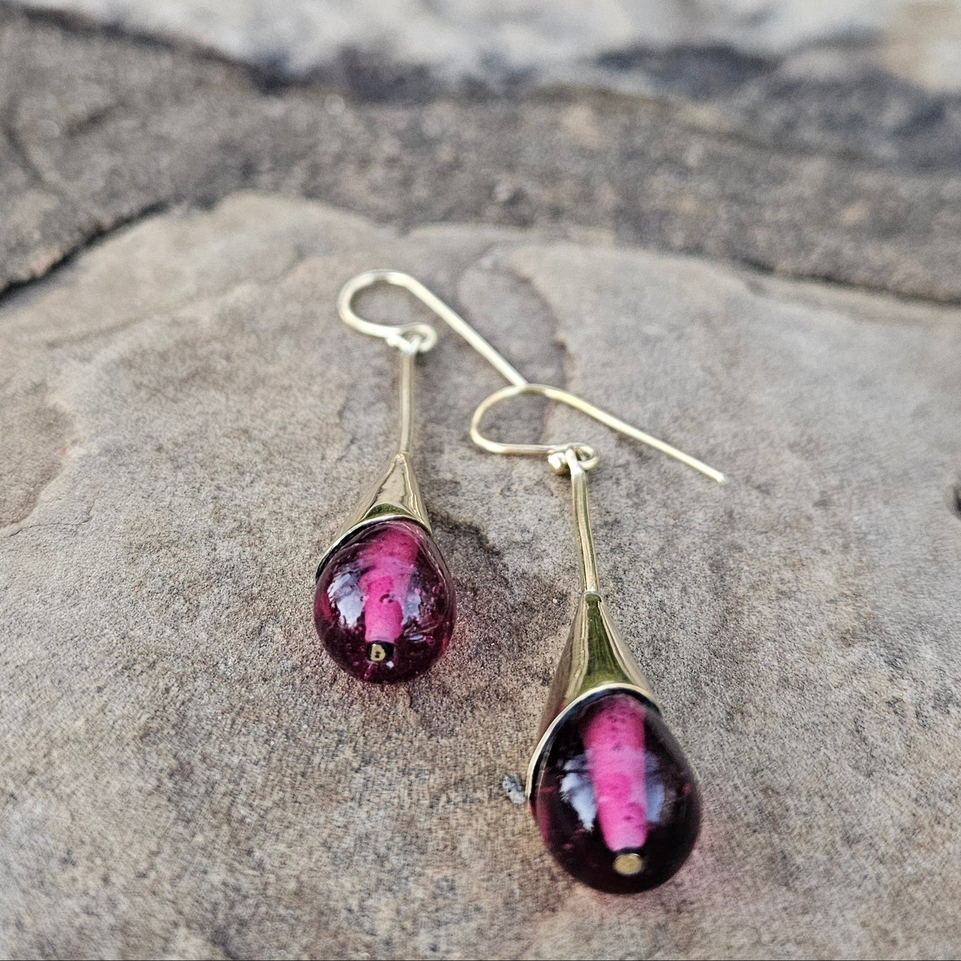 An image of gold & purple-color Brass threaders with rich purple glass drops. Shop Kamawe