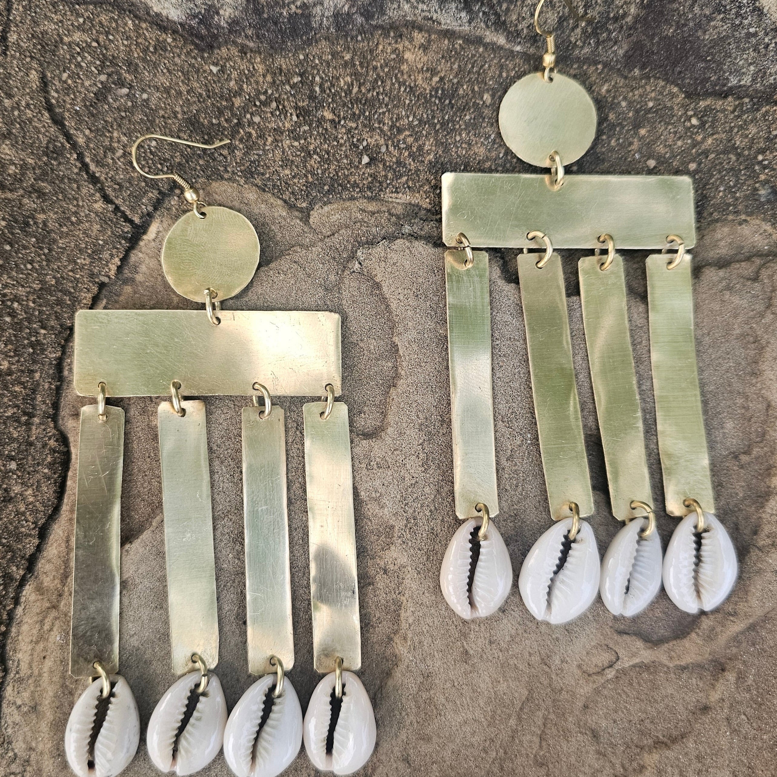 An image of gold & beige-color Vertical brass column earrings finished with cowrie. Shop Kamawe
