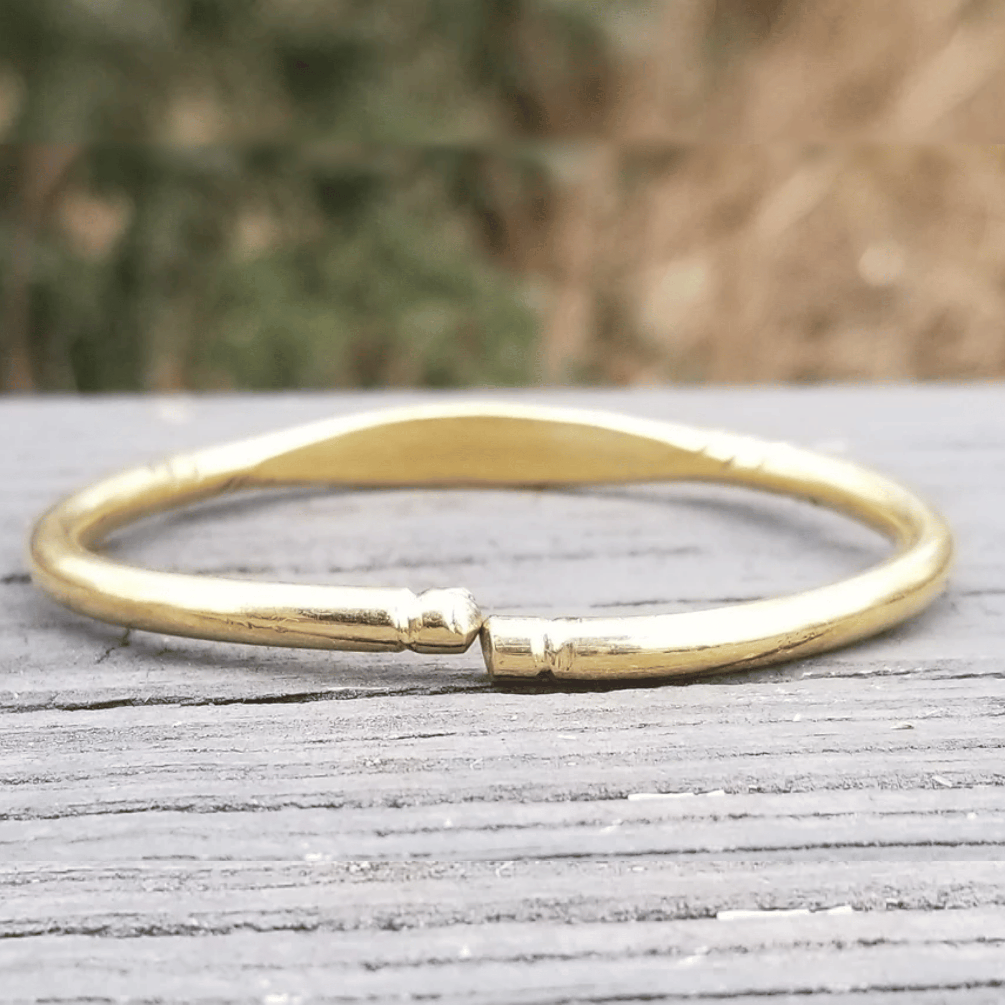 An image of Plain, burnished brass bangle with no surface engraving. Shop Kamawe