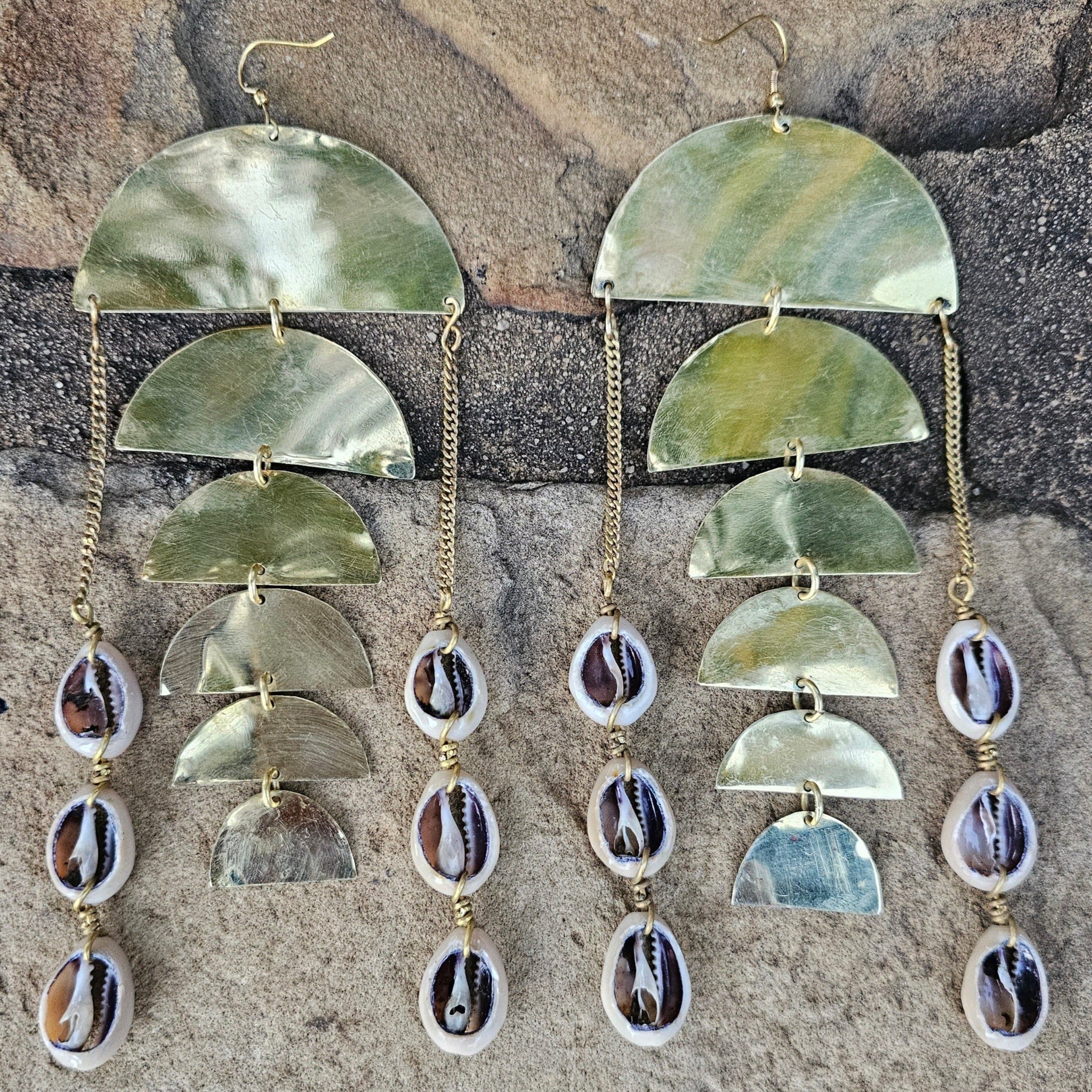 An image of gold & beige-color Scaled texture paired with hanging cowrie. Shop Kamawe