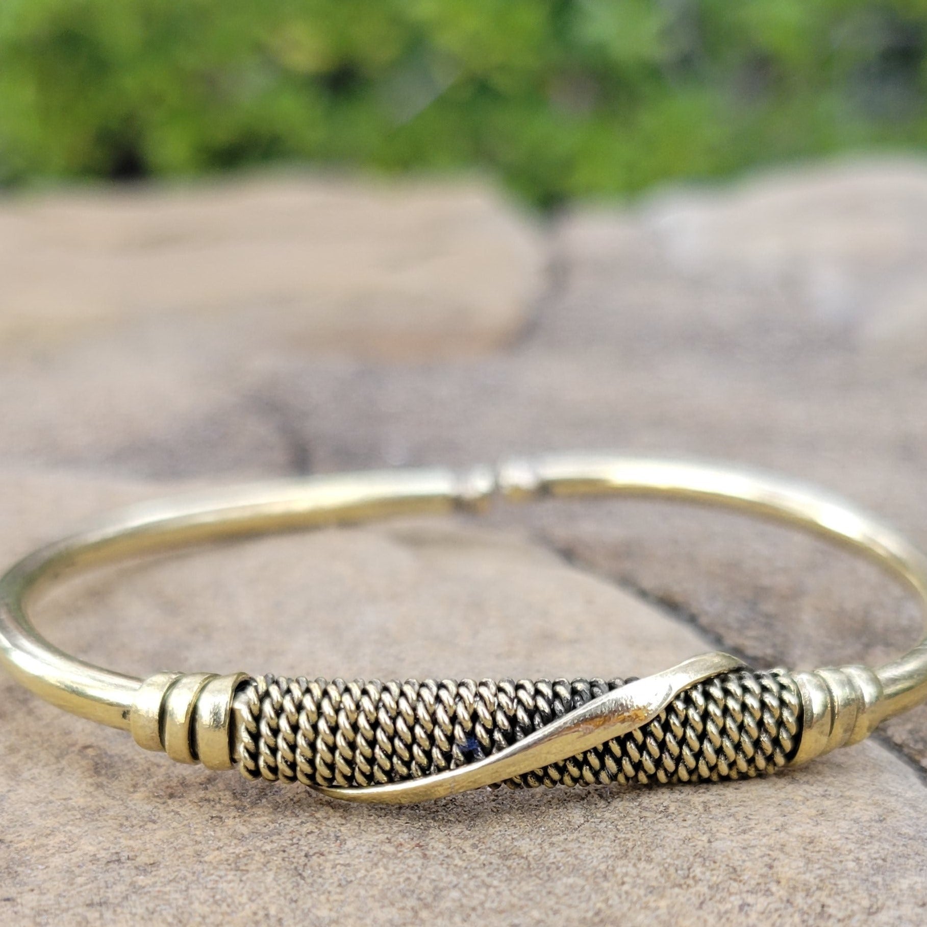 An image of Slim brass strip wrapped cleanly around the wrist. Shop Kamawe