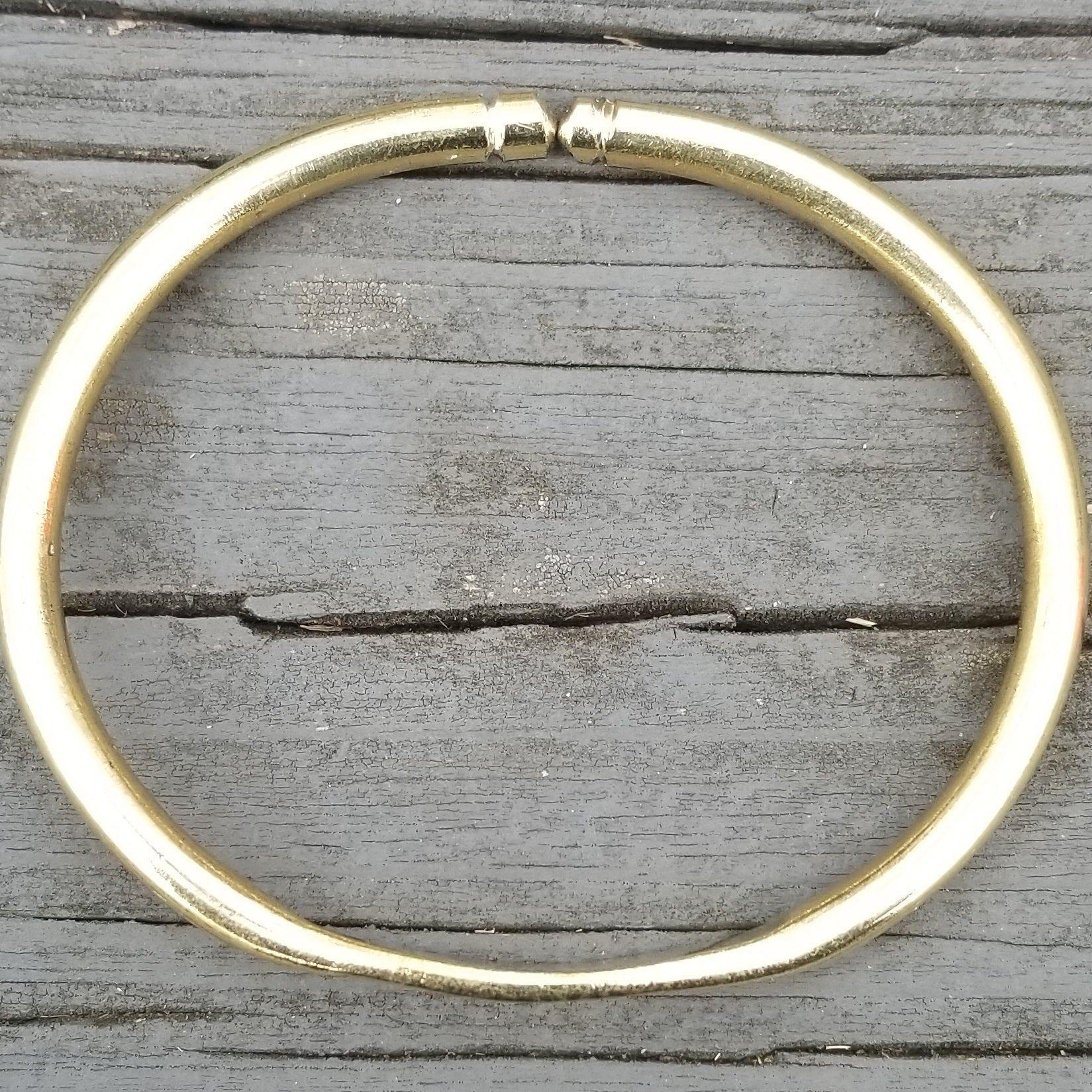 An image of Fine linear engraving running across a polished cuff. Shop Kamawe