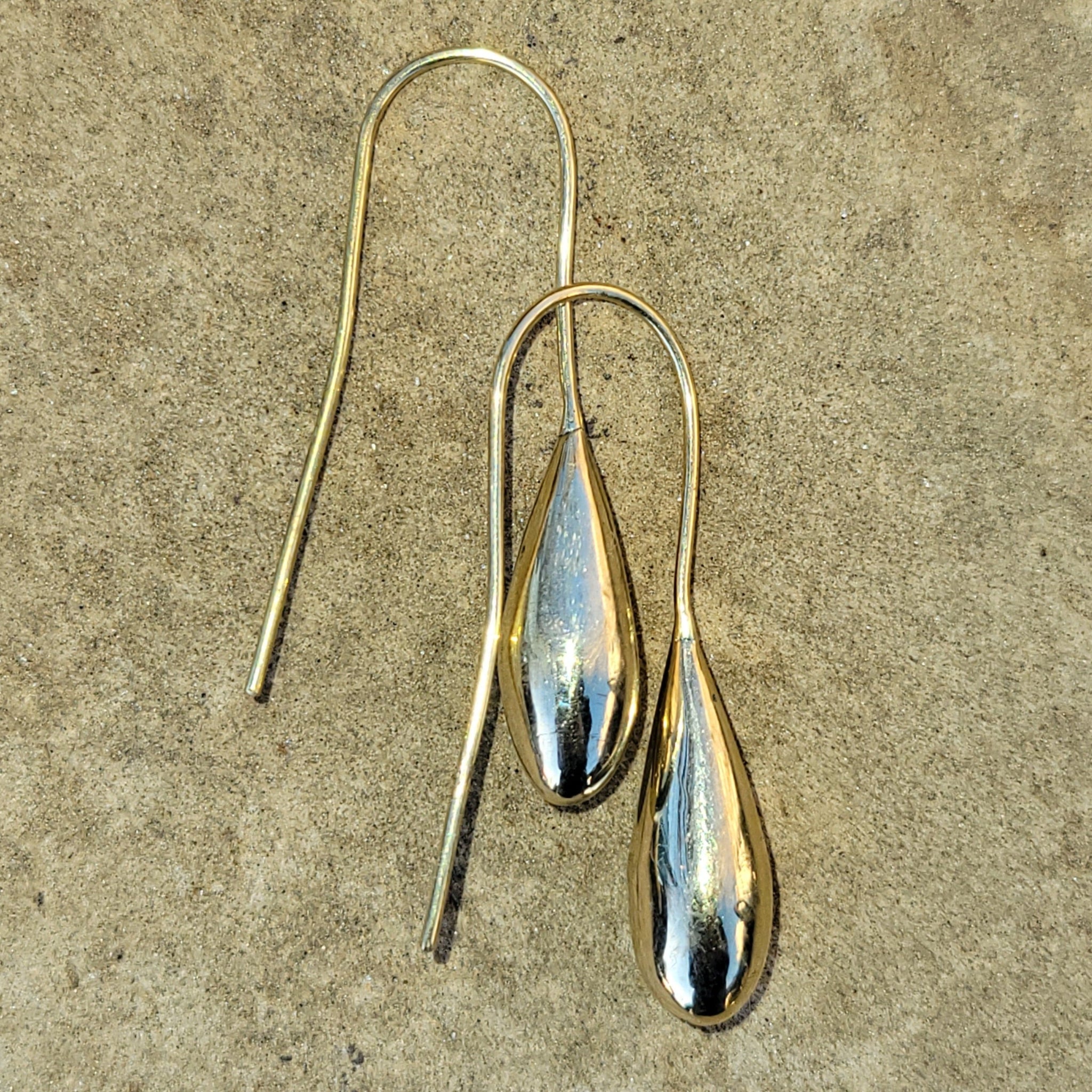 An image of gold-color Simple teardrop brass forms on sleek threaders. Shop Kamawe