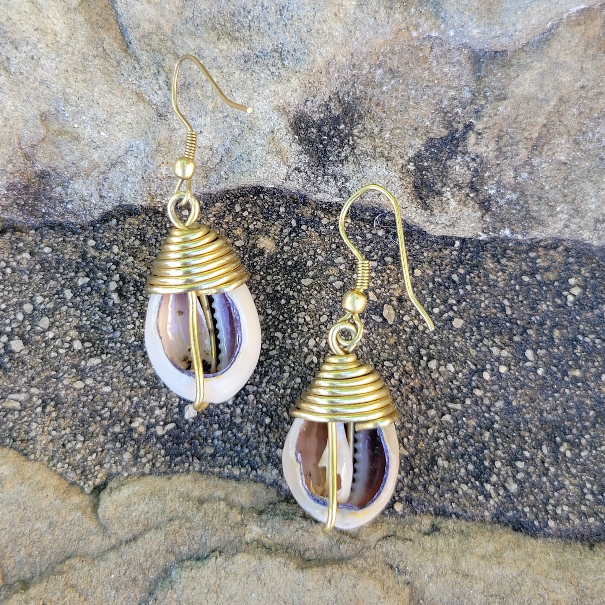An image of gold & beige-color Simple brass drop finished with one cowrie. Shop Kamawe
