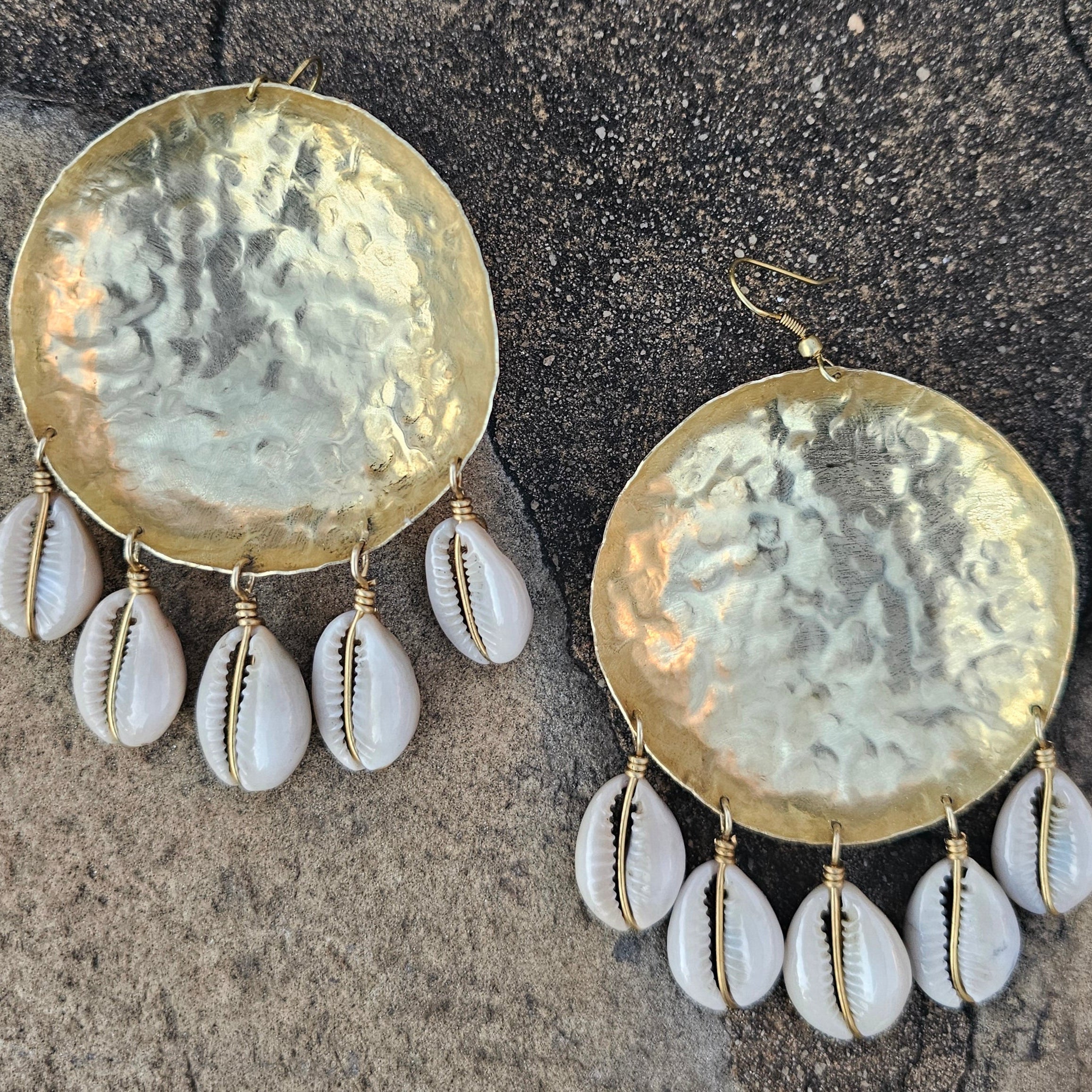 An image of gold & beige-color Bold bowl-shaped brass earrings crowned with cowrie. Shop Kamawe