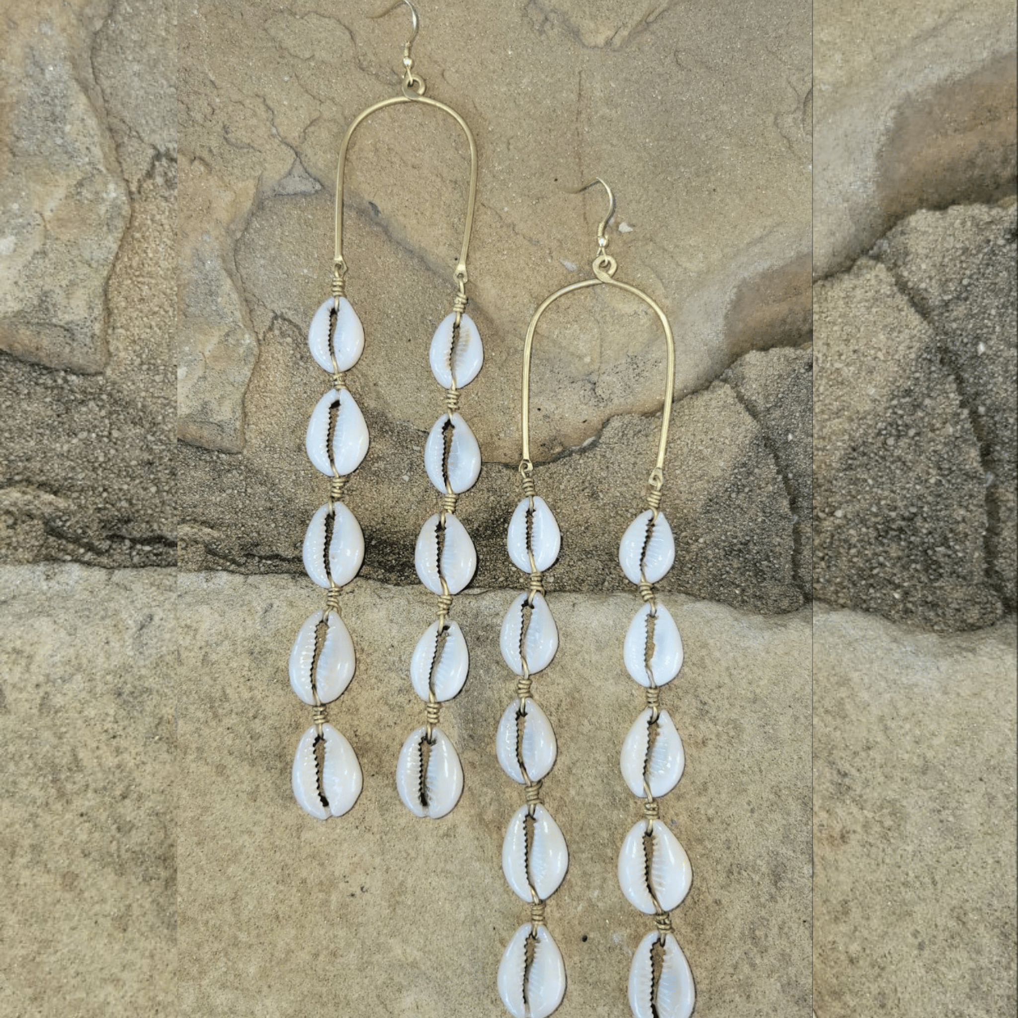 An image of gold & beige-color Long draping brass lines tipped with cowrie shells. Shop Kamawe
