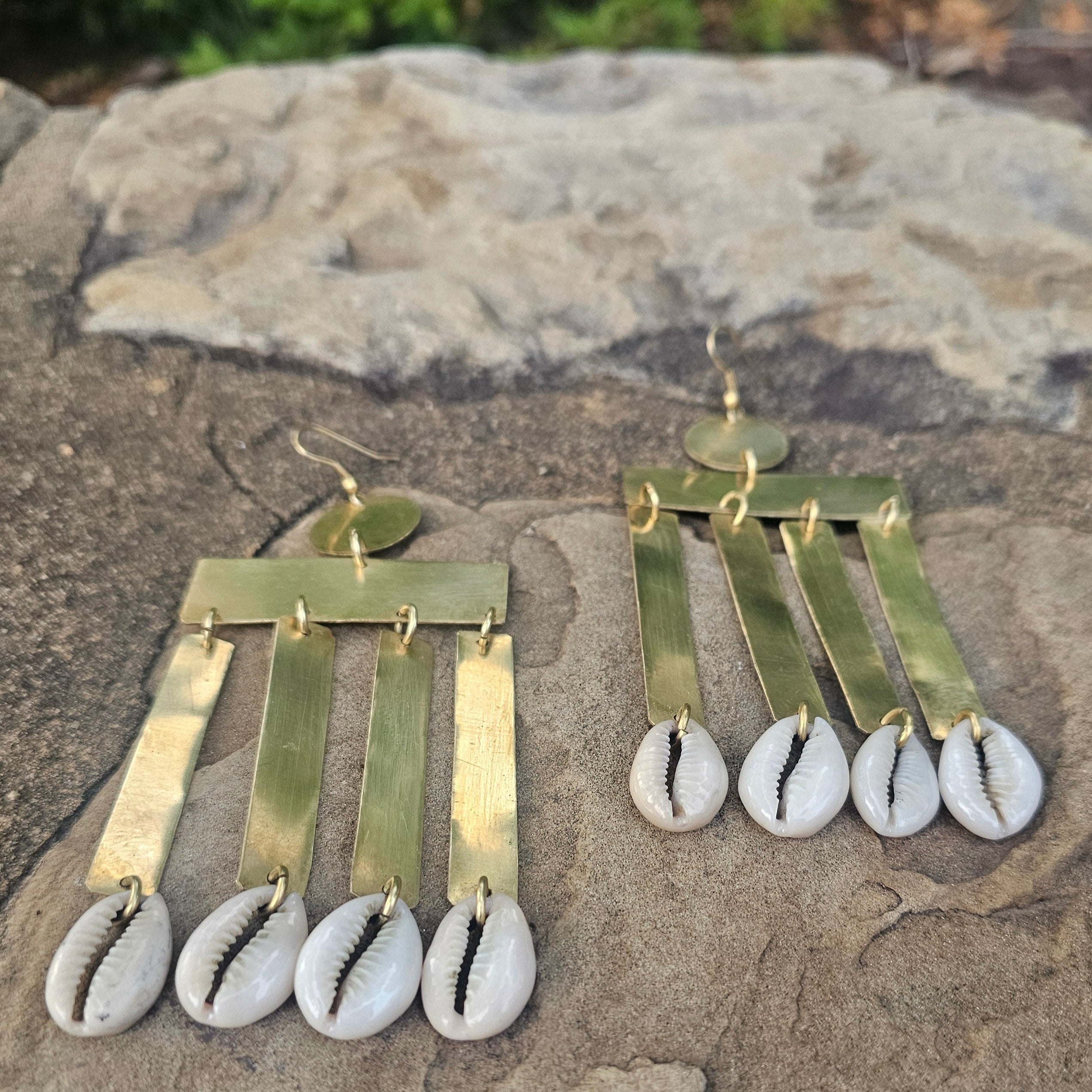 An image of gold & beige-color Vertical brass column earrings finished with cowrie. Shop Kamawe