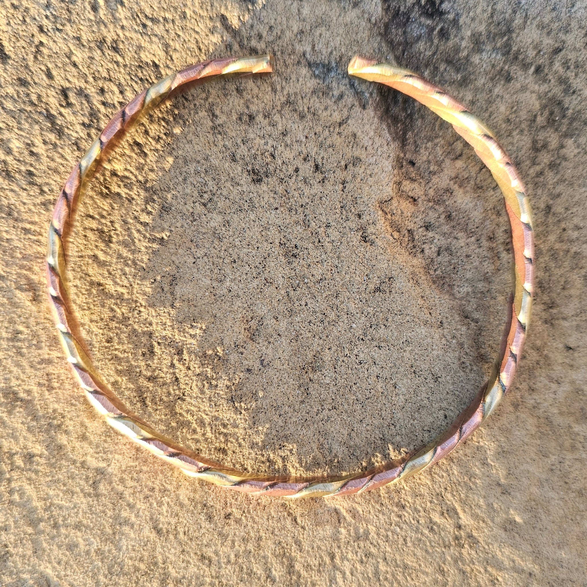 An image of bronze & gold-color Slim mixed-metal twist bracelet in copper and brass for minimalist wear. Shop Kamawe