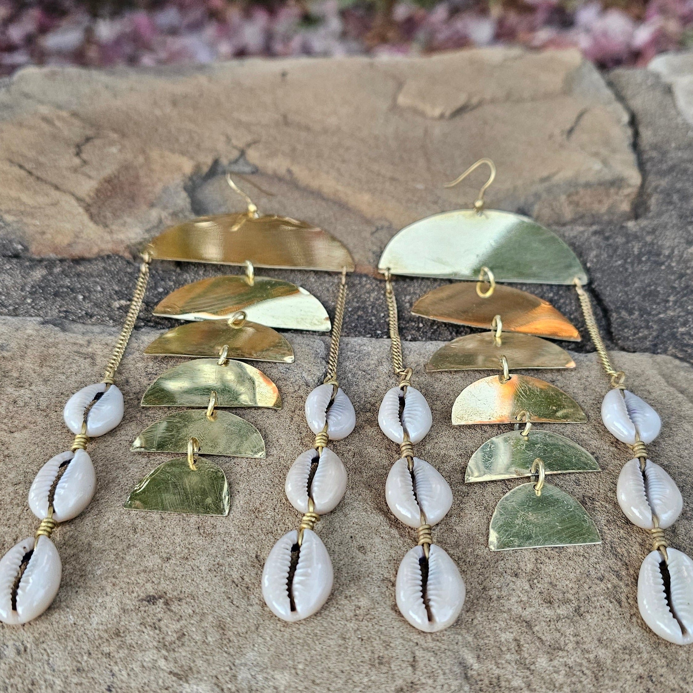 An image of gold & beige-color Scaled texture paired with hanging cowrie. Shop Kamawe