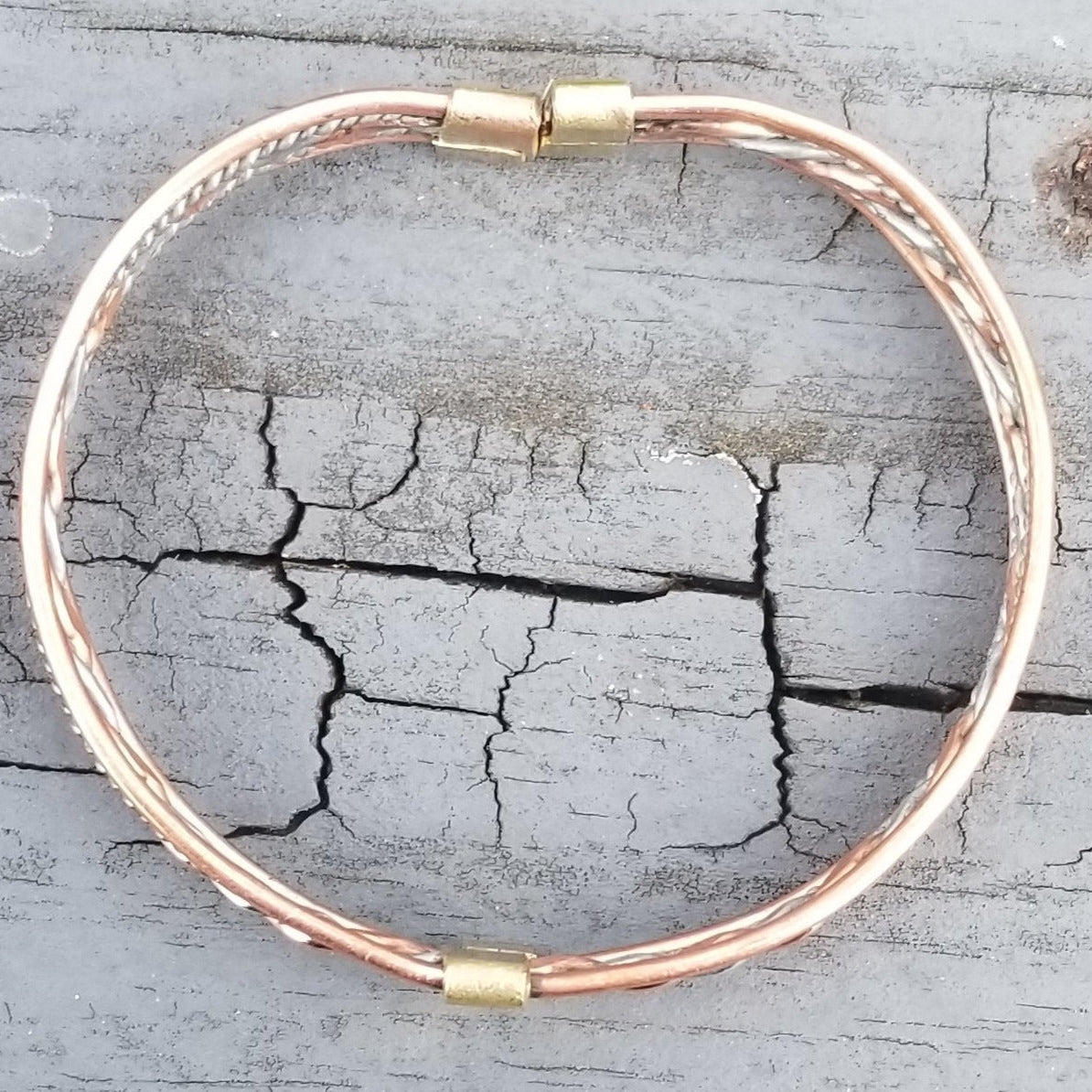 An image of Tightly twisted strands mixing contrasting metal hues. Shop Kamawe