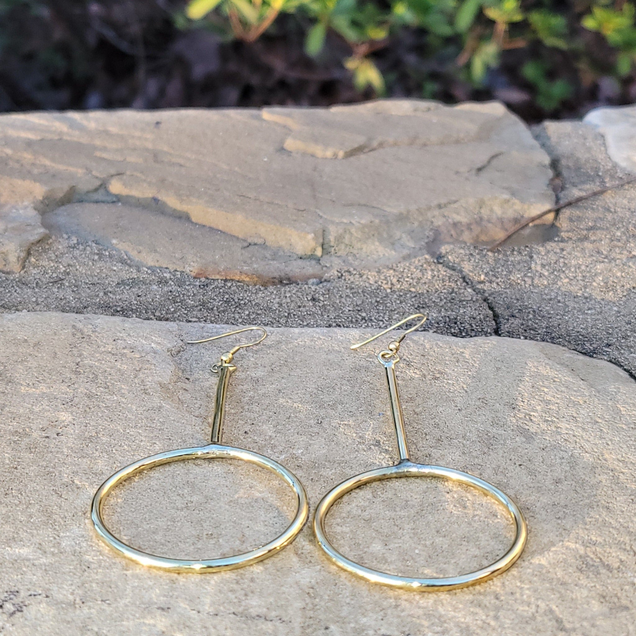 An image of gold-color Long, narrow hoops that stretch the classic silhouette. Shop Kamawe