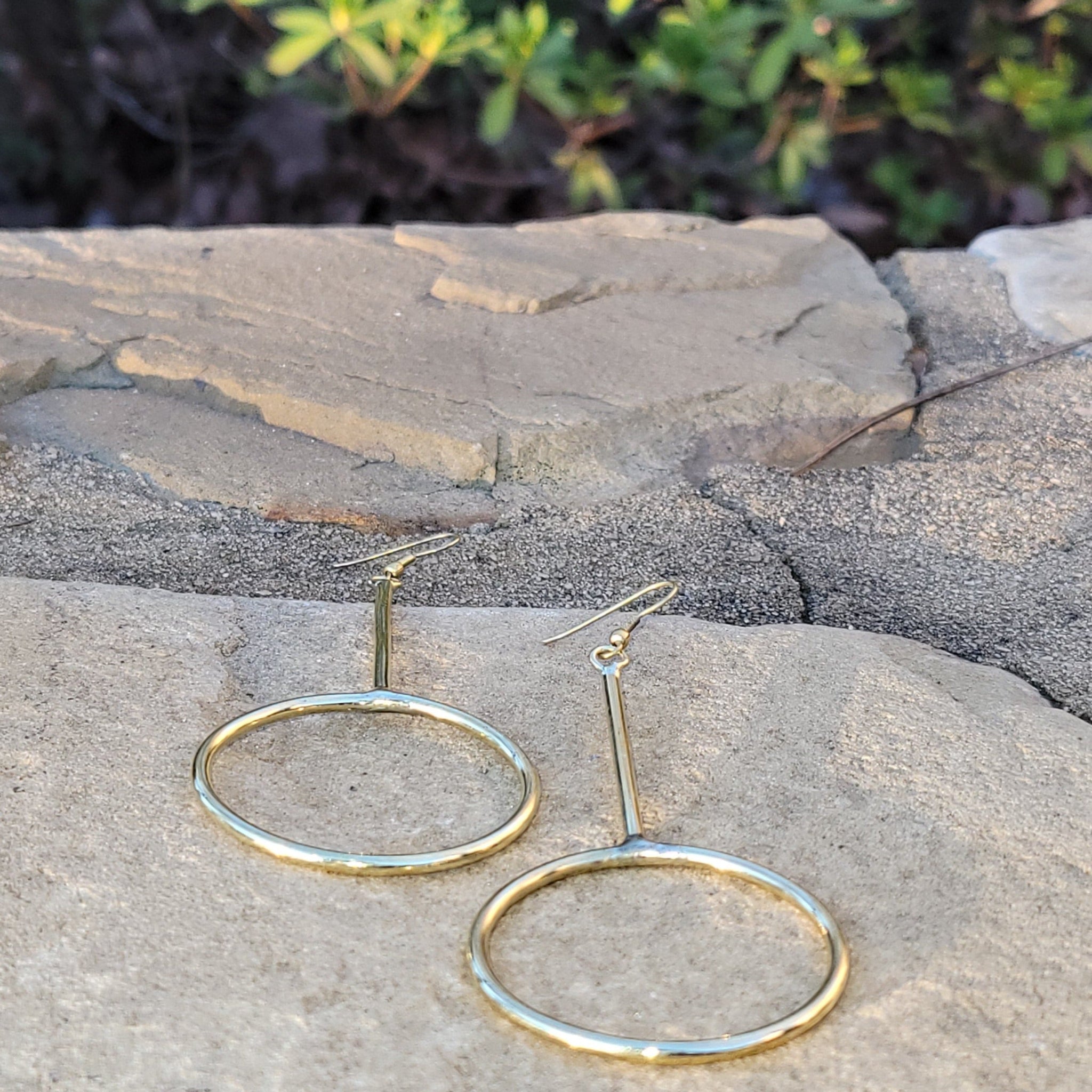 An image of gold-color Long, narrow hoops that stretch the classic silhouette. Shop Kamawe