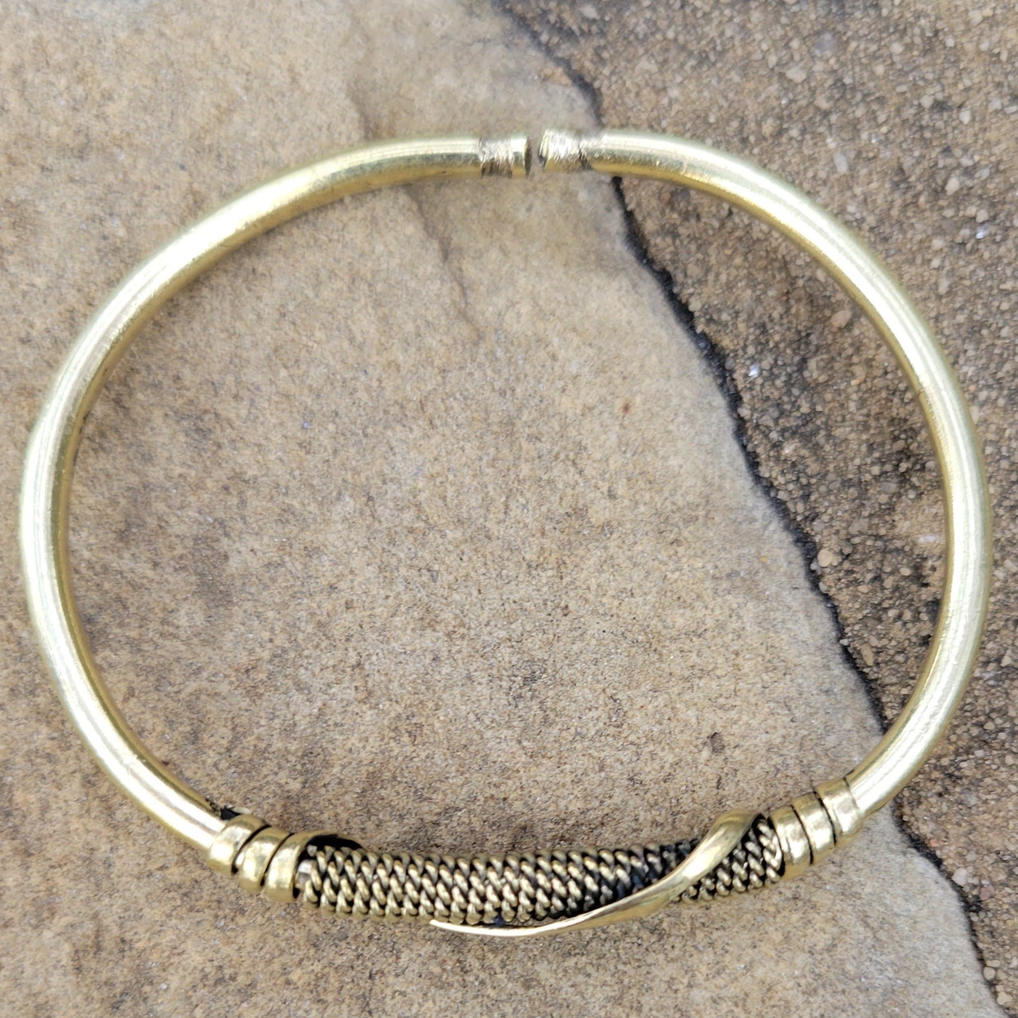 An image of Slim brass strip wrapped cleanly around the wrist. Shop Kamawe