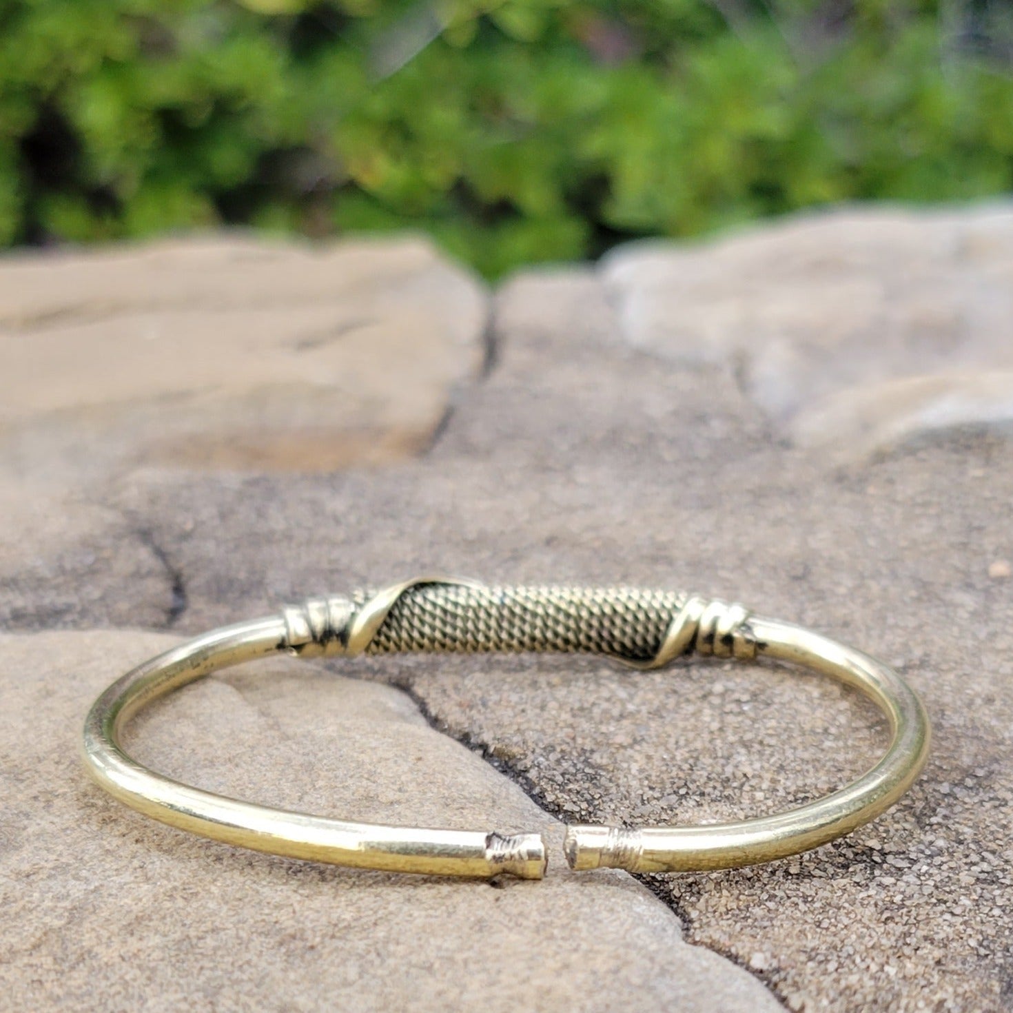 An image of Slim brass strip wrapped cleanly around the wrist. Shop Kamawe
